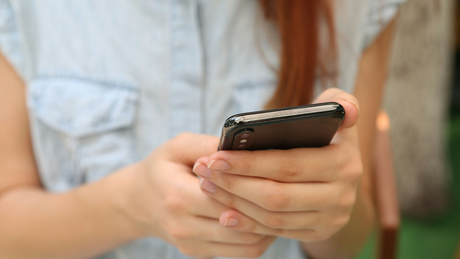 person holding using iPhone X