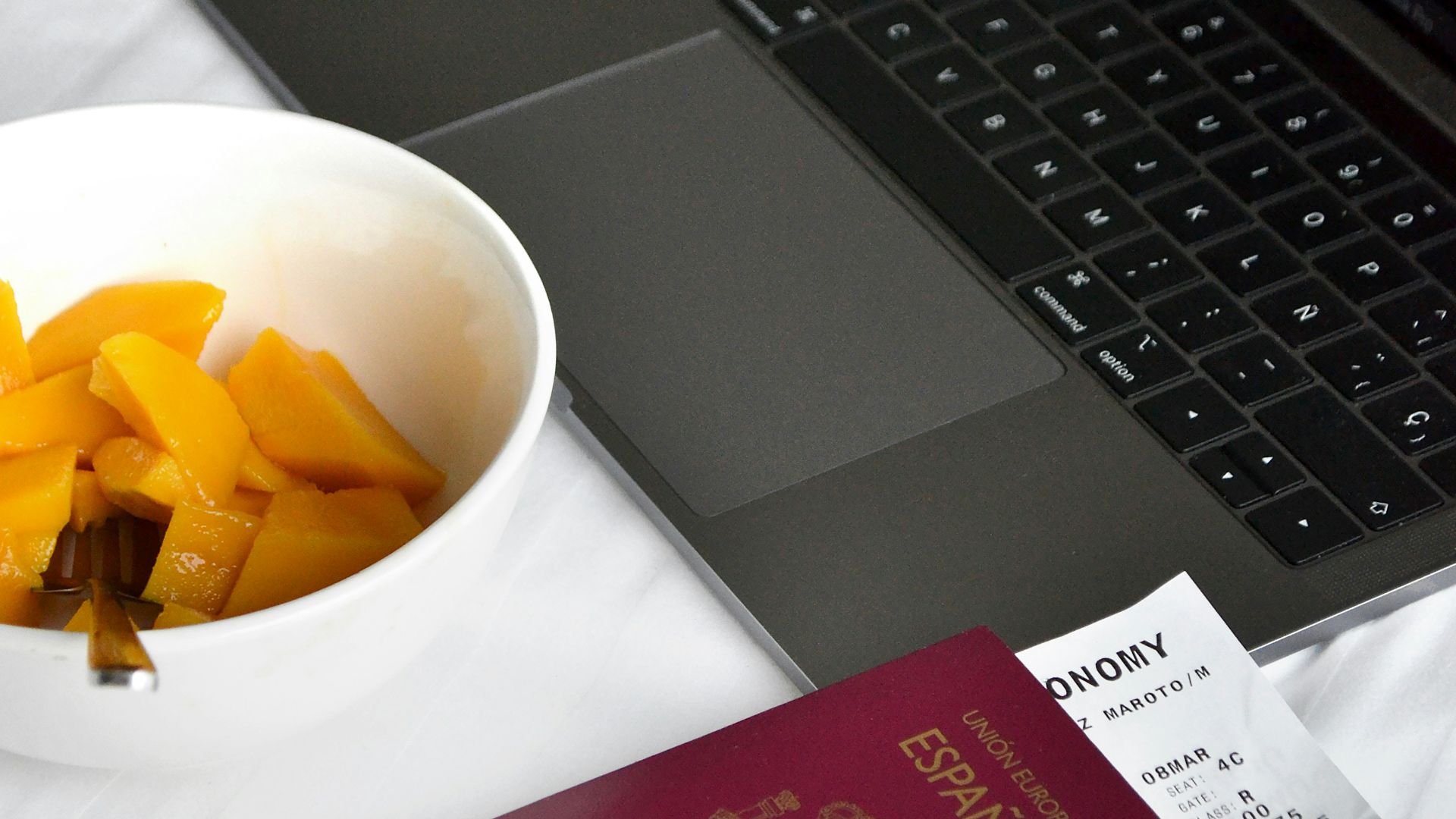 Travel essentials, passport, laptop and breakfast.