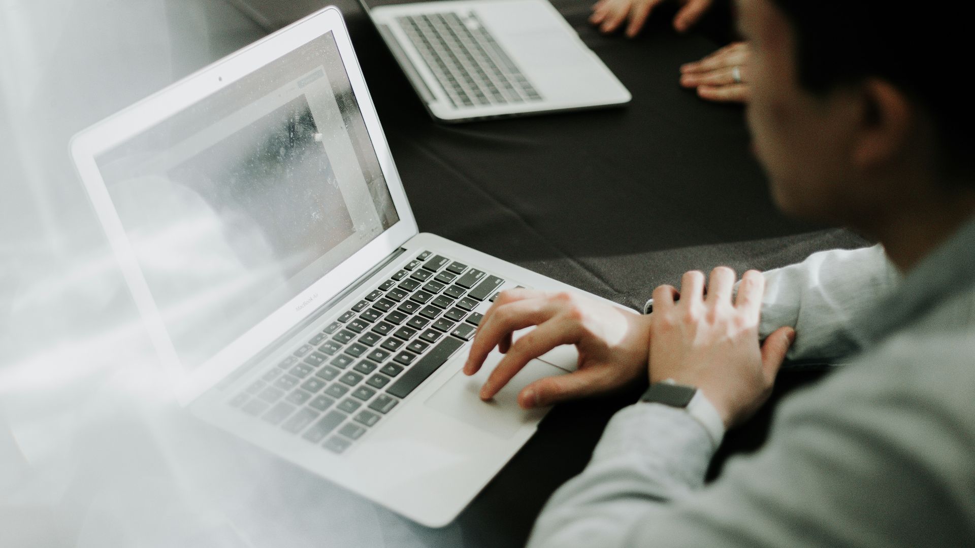 a man sitting in front of a laptop computer
