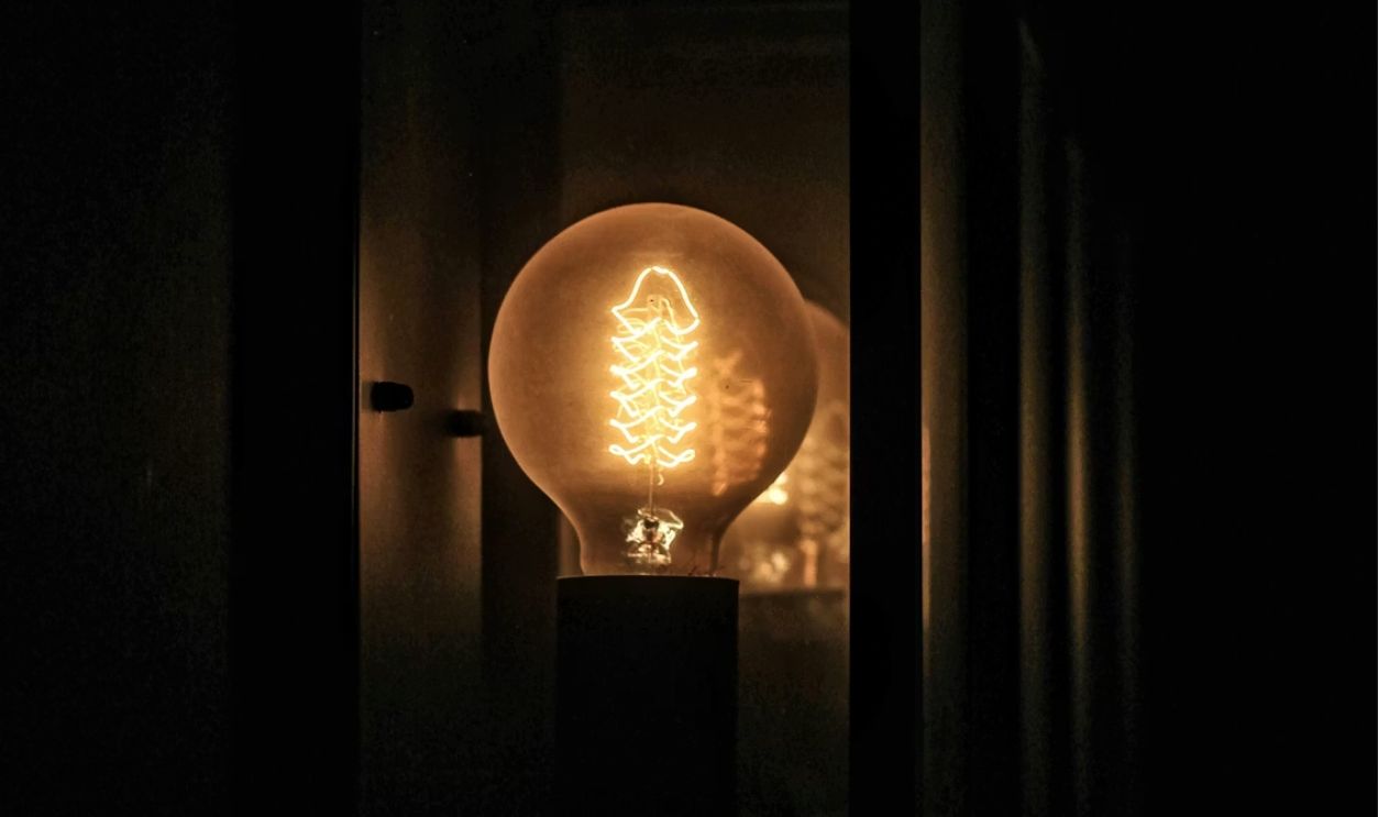 A glowing light bulb in a dark room