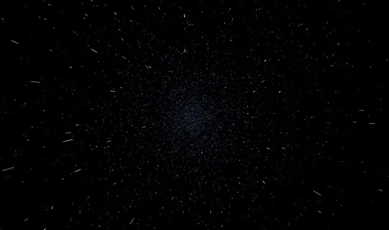 Abstract dark background with scattered white and blue particles.