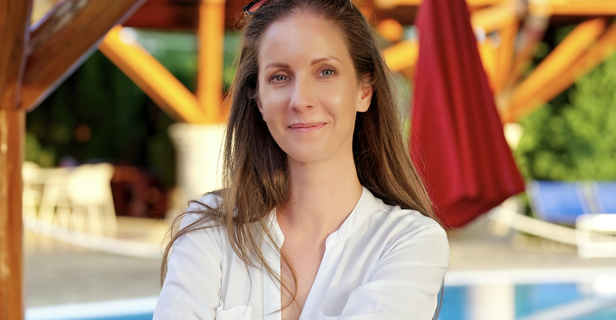 Portrait of happy satisfied woman in hotel garden on vacation, smiling. Poolside at home in summer morning.