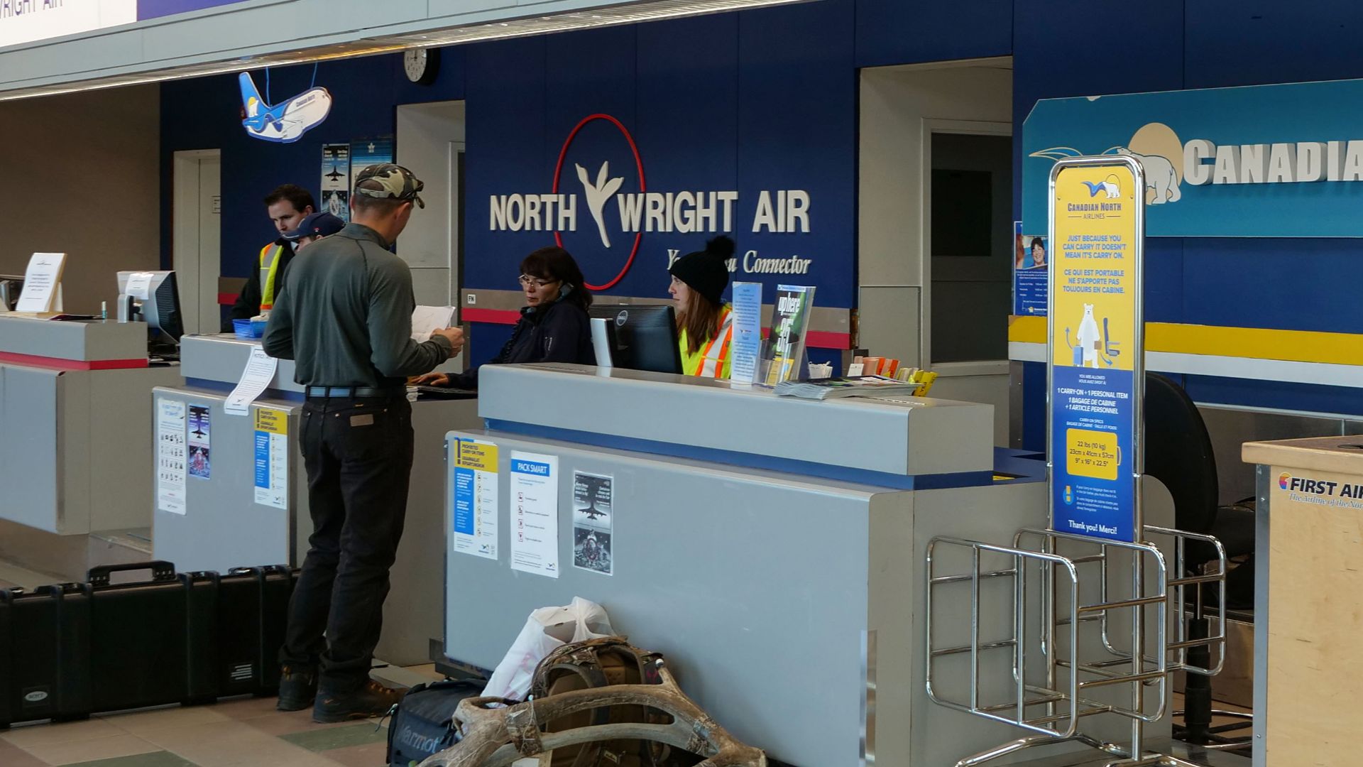 Canadian North and North-Wright Airways check-in counters inside Norman Wells Airport (YVQ).