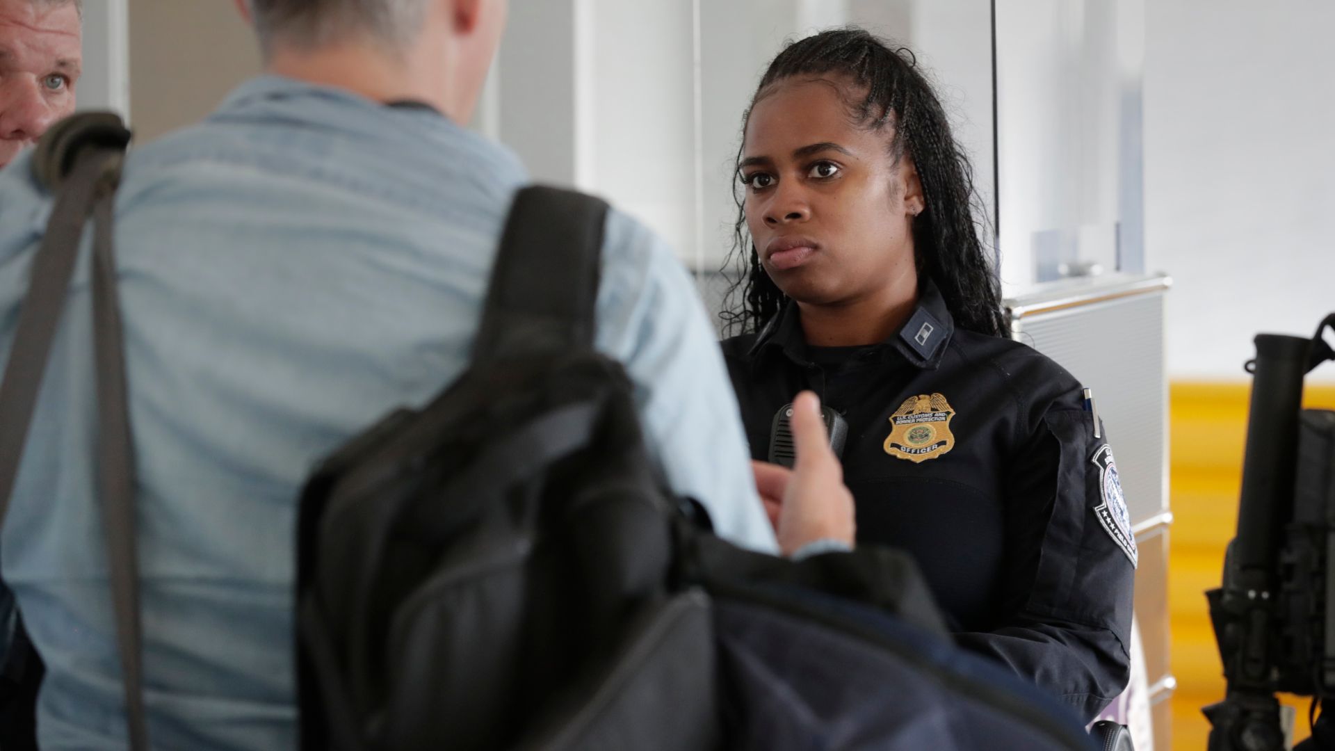 A U.S. Customs and Border Protection officer asks questions of an arriving international passenger in the baggage claim area at Philadelphia International Airport in Philadelphia, Pa., July 29, 2024. CBP Photo by Glenn Fawcett