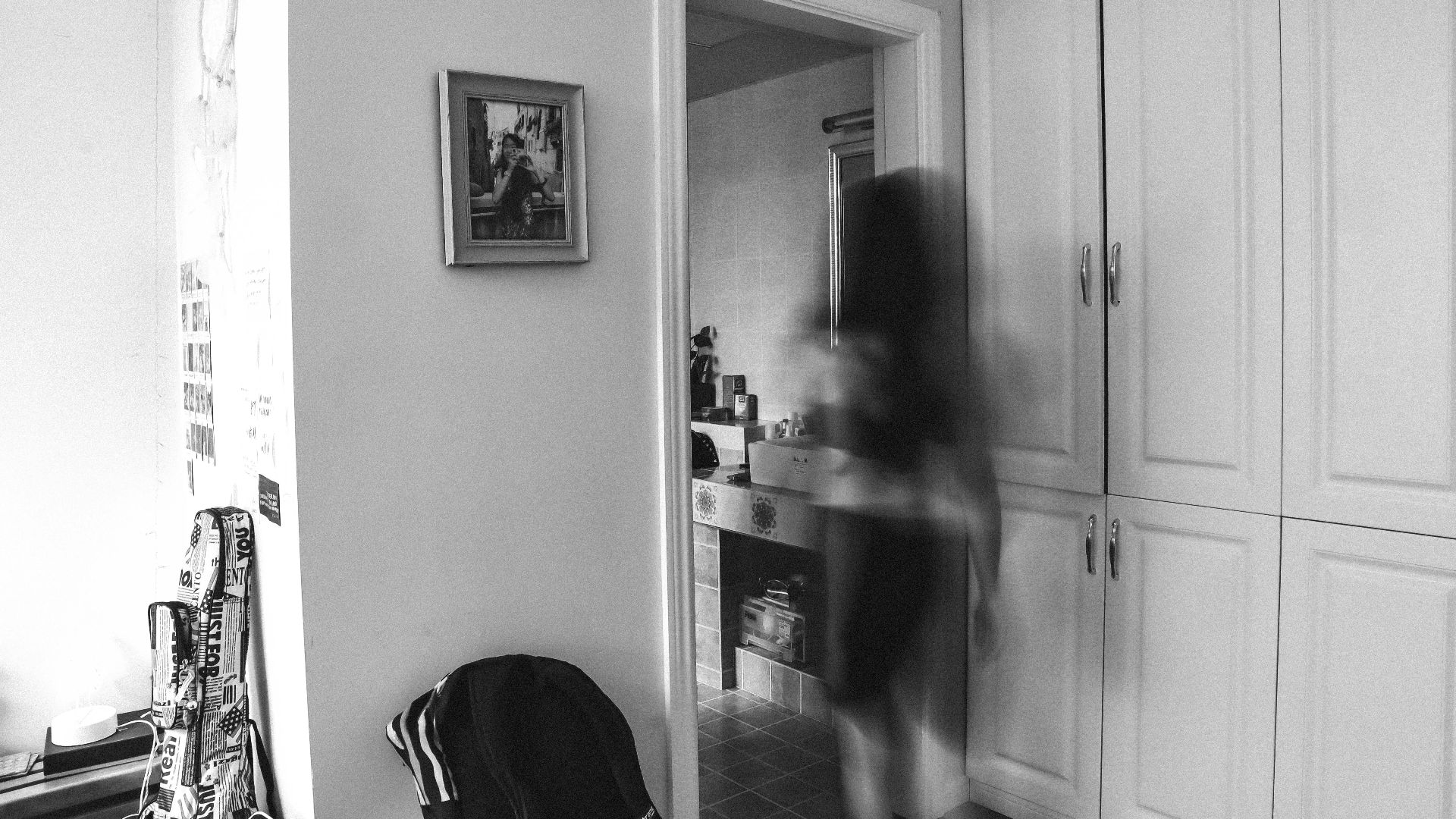 a black and white photo of a person in a room