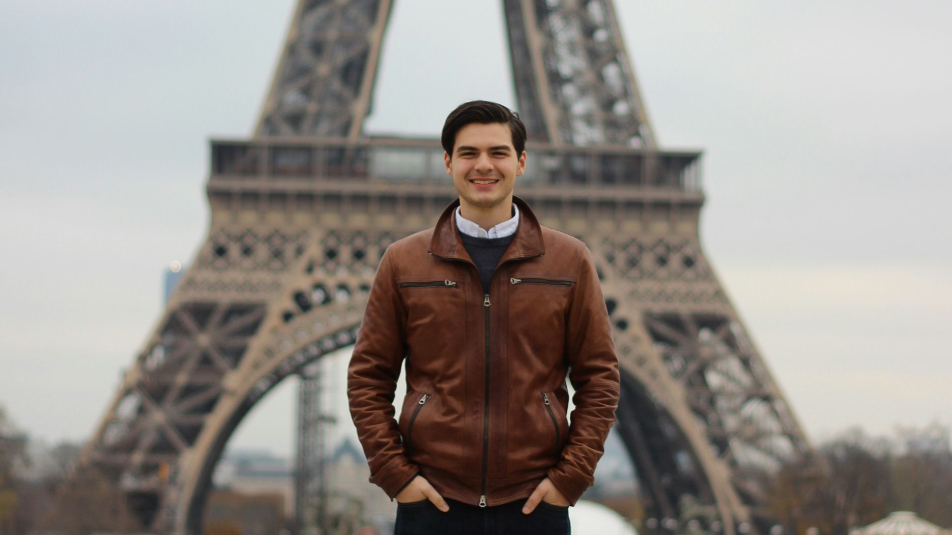 man standing near Eiffel tower