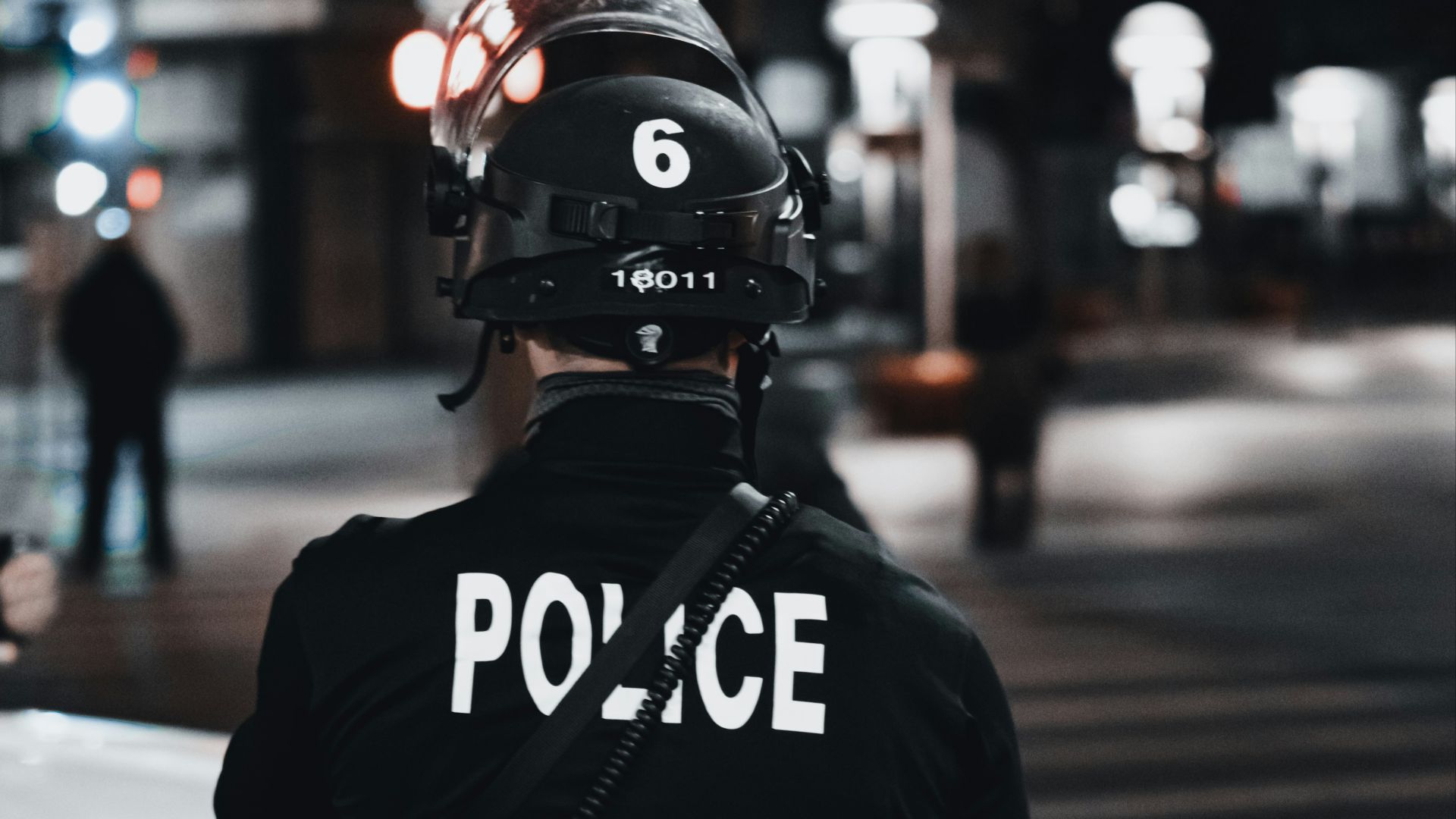 man in black and white adidas jacket and black helmet standing on road during daytime