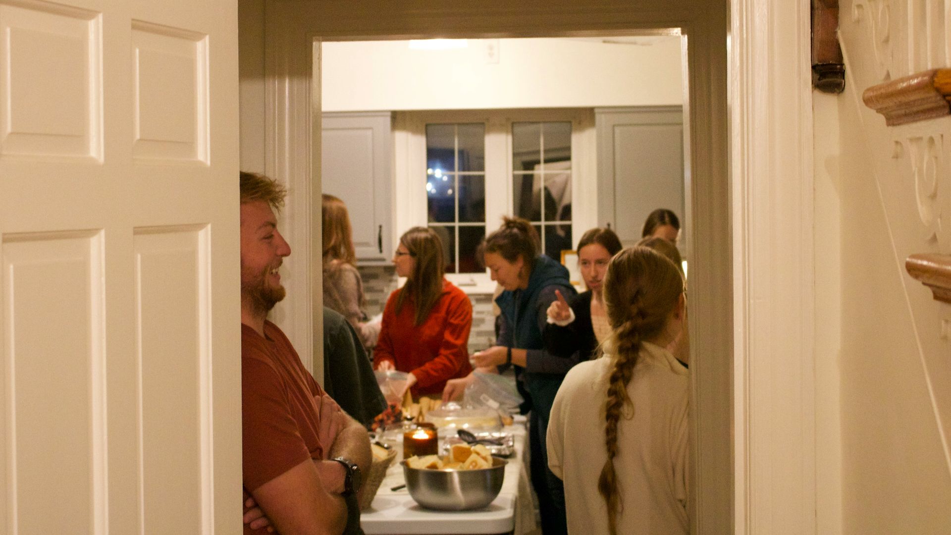 People gathered in a kitchen during a party.