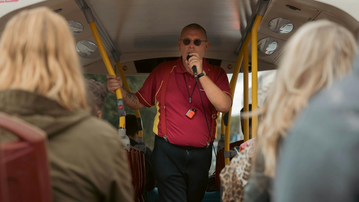 Tour Guide Leading Open-Top London Bus Tour