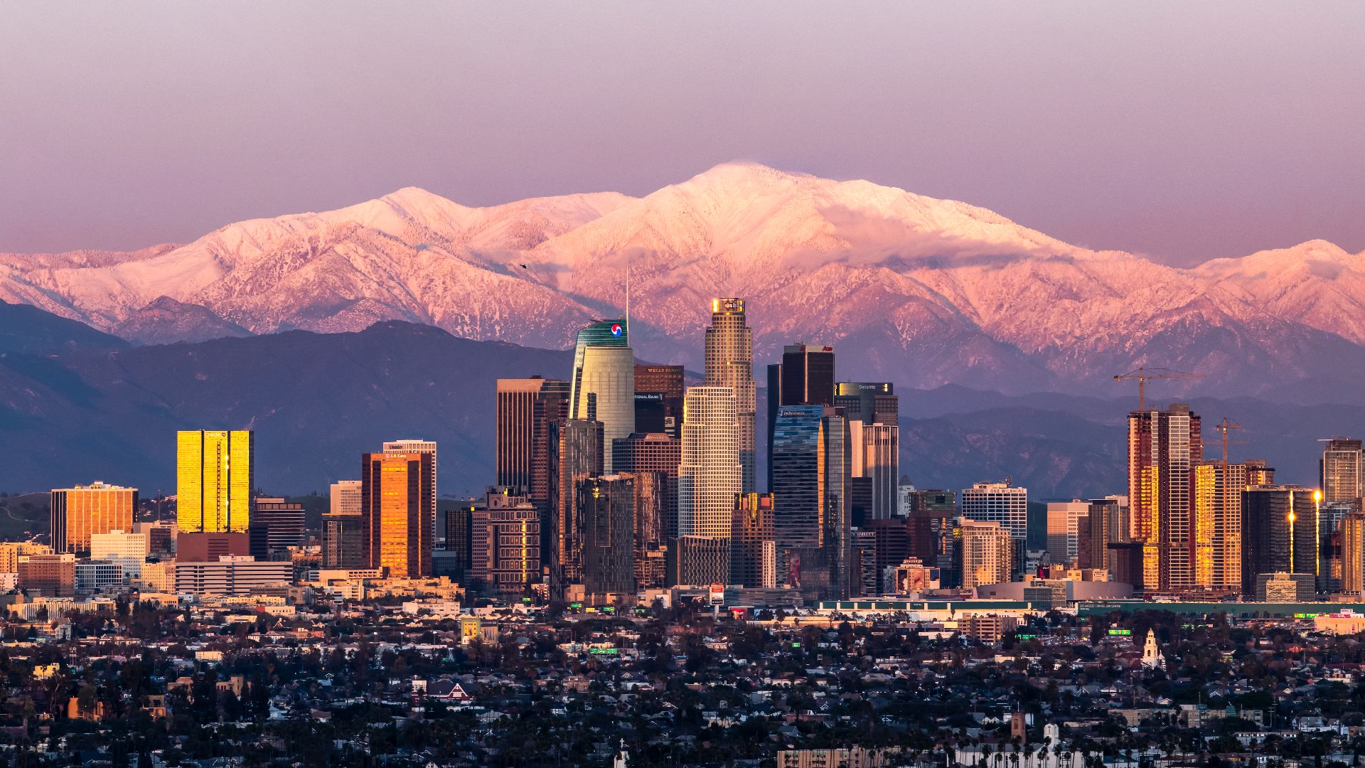 February shot of downtown Los Angeles sunset with Mount Baldy in the background after a large snow storm.