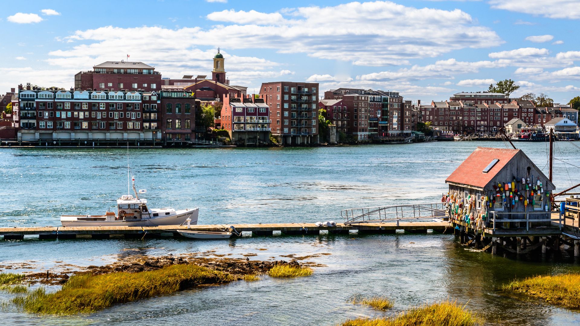 View towards the commercial strip along Bow and Market Streets in Portsmouth, New Hampshire. The small shack in the foreground is across Memorial Bridge on Badger's Island in Kittery, Maine.