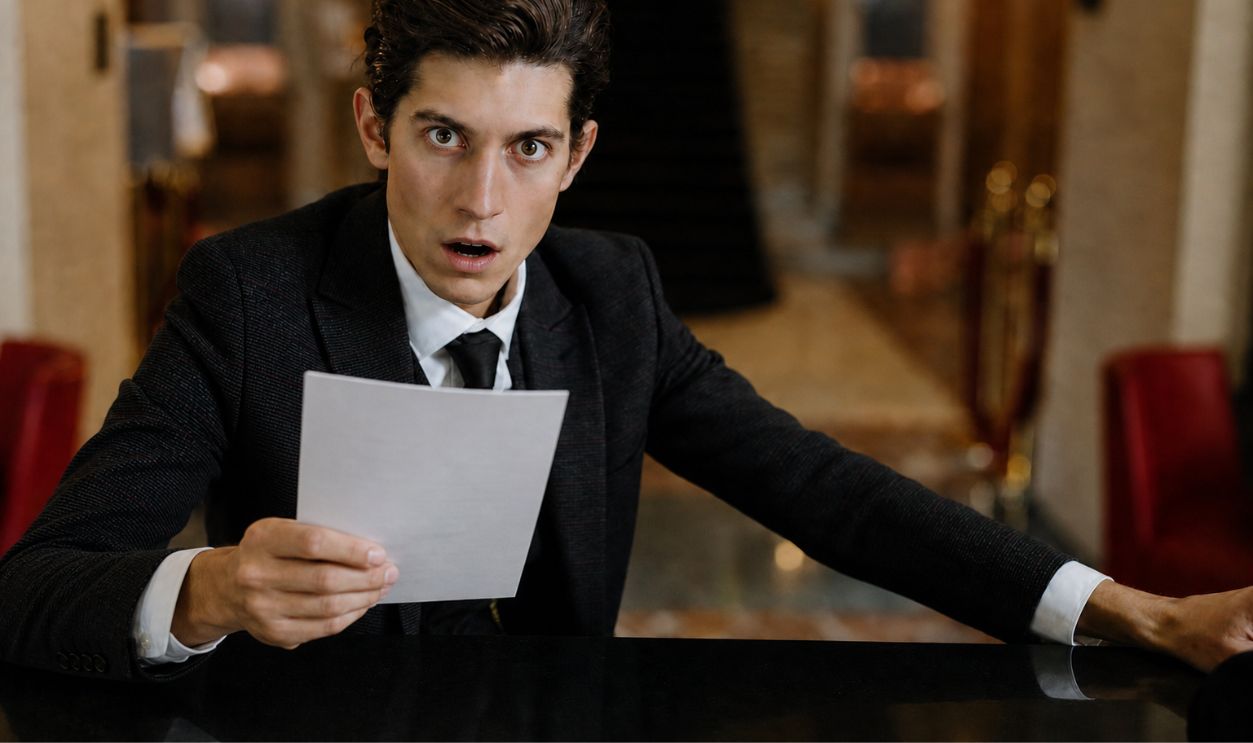 Shocked Man Holding A Document
