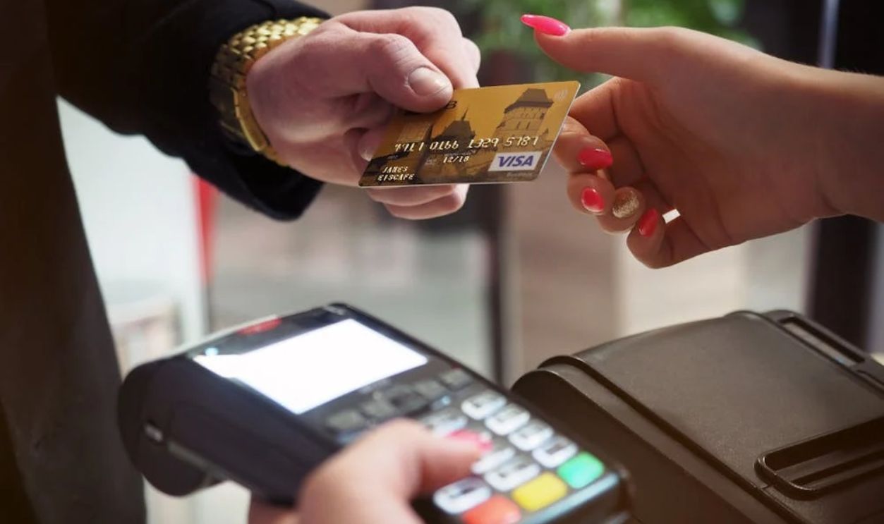 Close-up of a credit card payment being processed at a POS terminal.