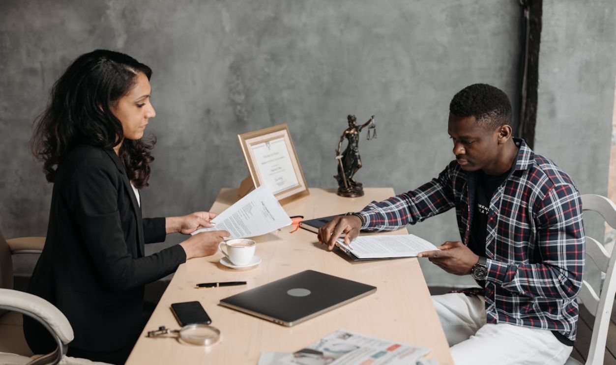 Business professionals discussing documents in a modern office setting.