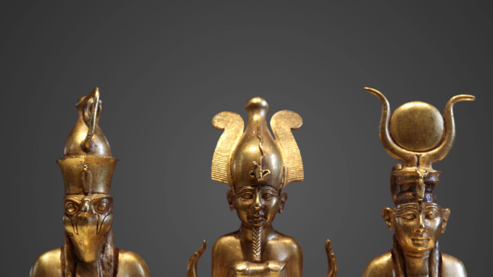 The family of Osiris. Osiris on a lapis lazuli pillar in the middle, flanked by Horus on the left and Isis on the right (22nd dynasty, Louvre, Paris) 