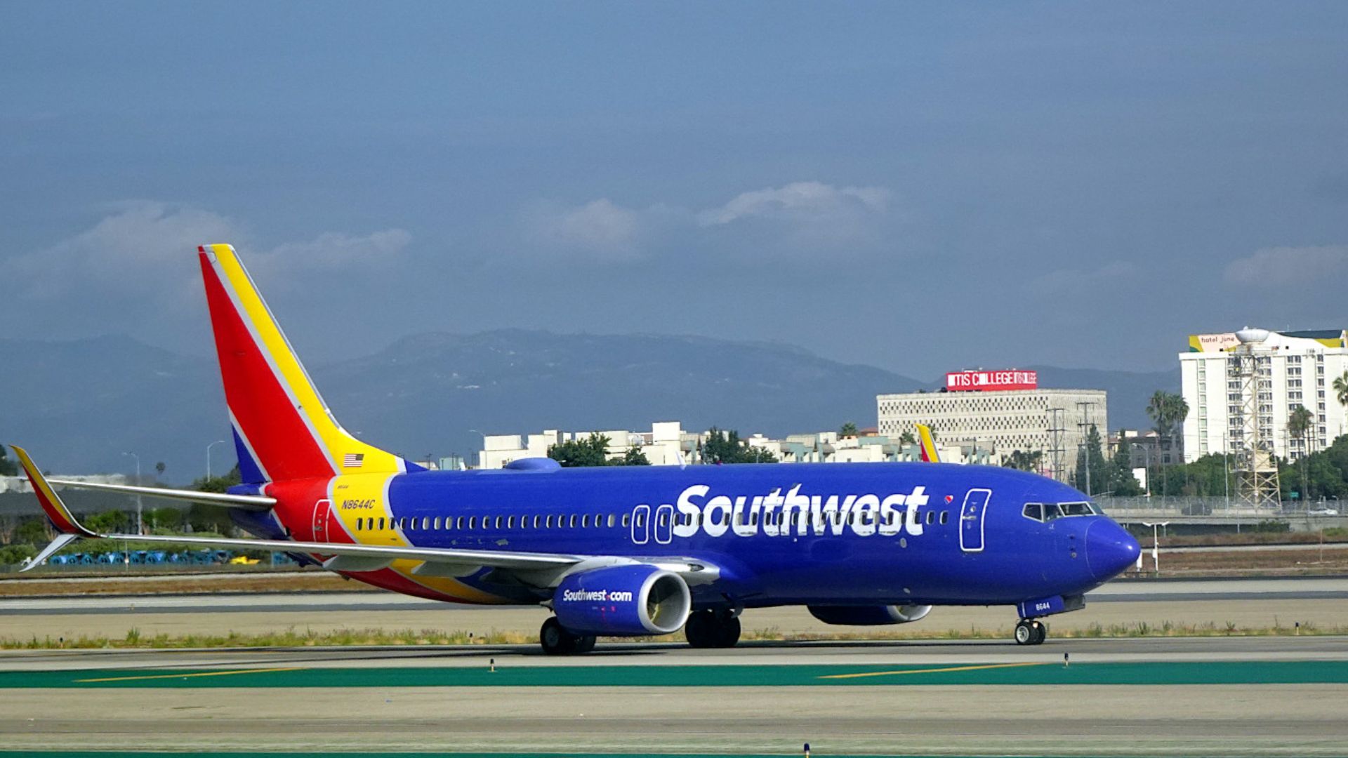 A 2014 Southwest Boeing 737-800 taxiing at Los Angeles International Airport. Registration N8644C. The paint on this aircraft is slightly peeling. Aircraft Manufacturer Serial Number 35973. Officially a Boeing 737-8H4 with Southwest's customer code.