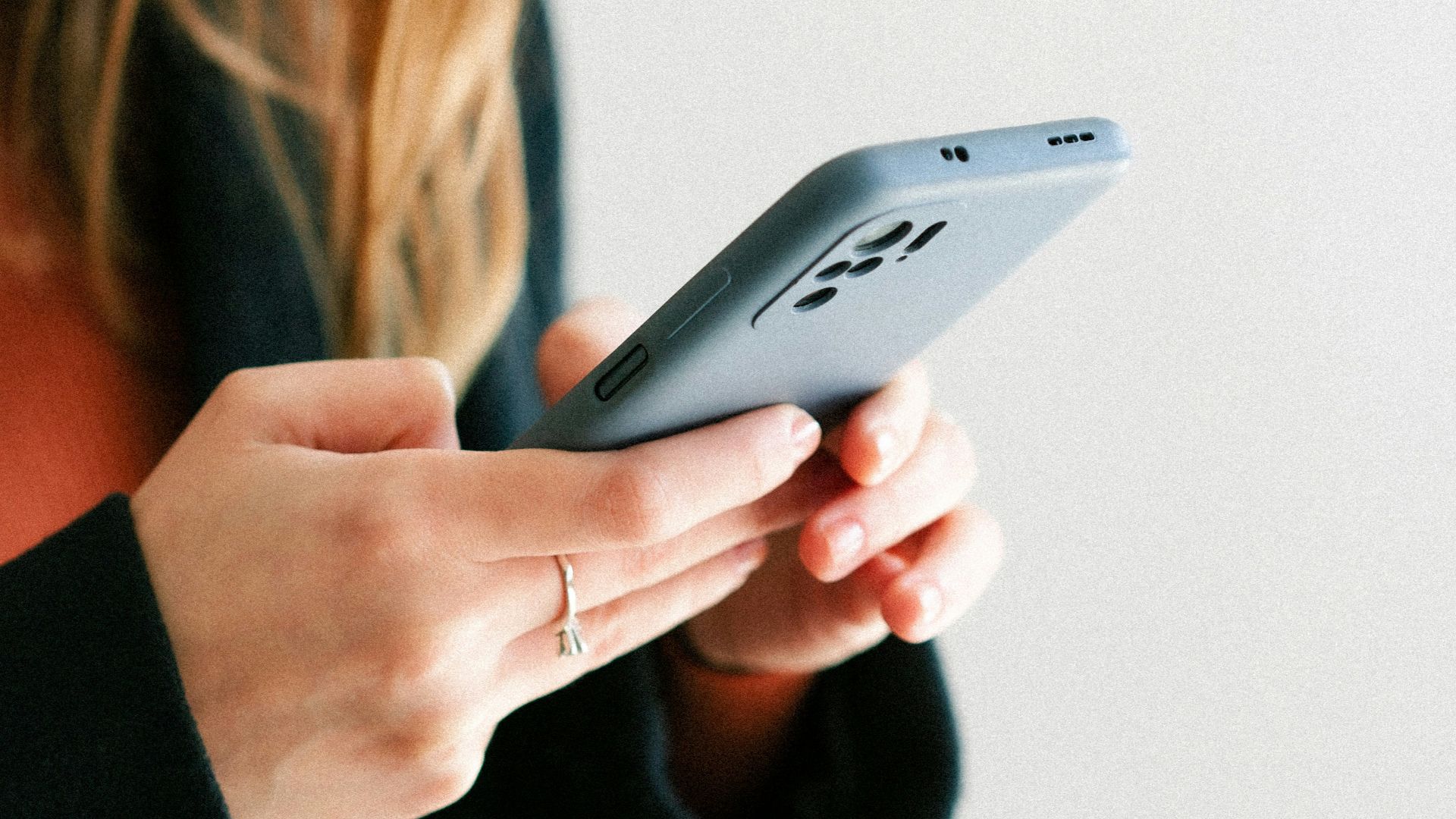 a woman holding a cell phone in her hands
