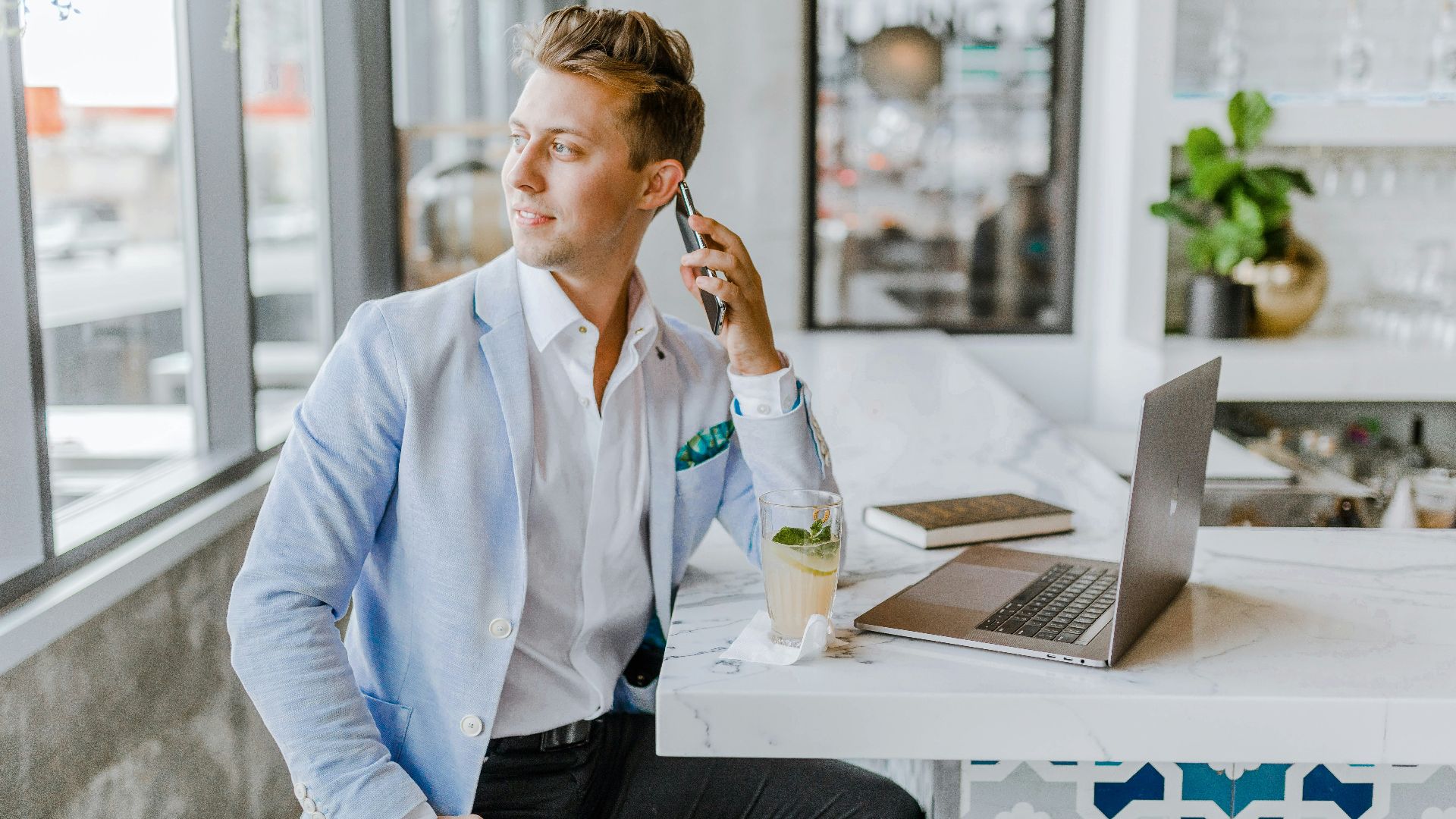 man sitting beside white wooden table