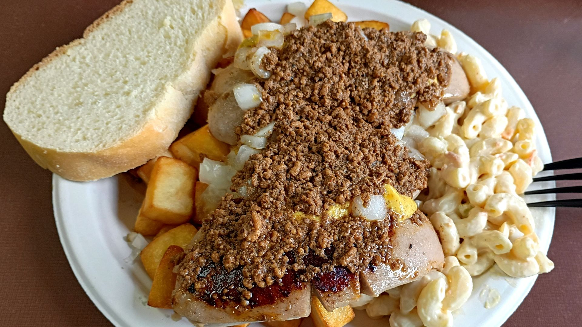 A Nick Tahou's Garbage Plate is a  dish featuring a combination of home fries, macaroni salad, white hots, topped with mustard, onions, and a spicy meat sauce. Traditionally served with Italian bread and butter.