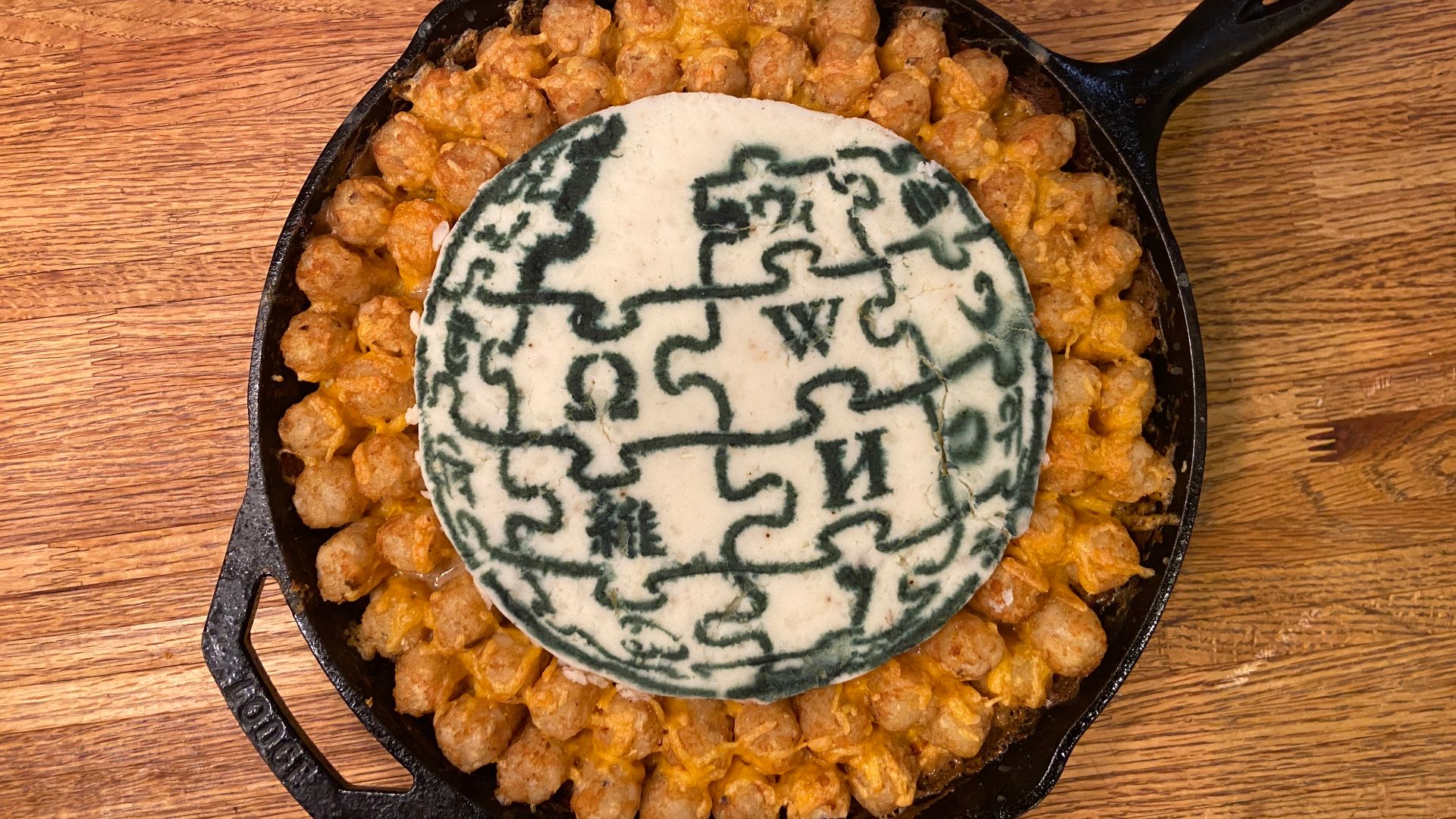 Wikipedia Tater Tot Hotdish with mashed potato medallion featuring a stenciled Wikipedia logo.
Created as a test run for the 2025 Wikipedia Day Celebration in Minnesota.