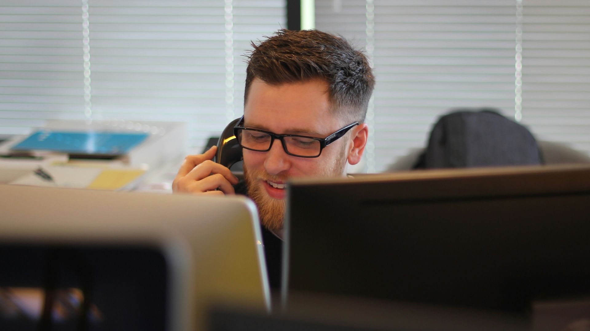 man using IP phone inside room