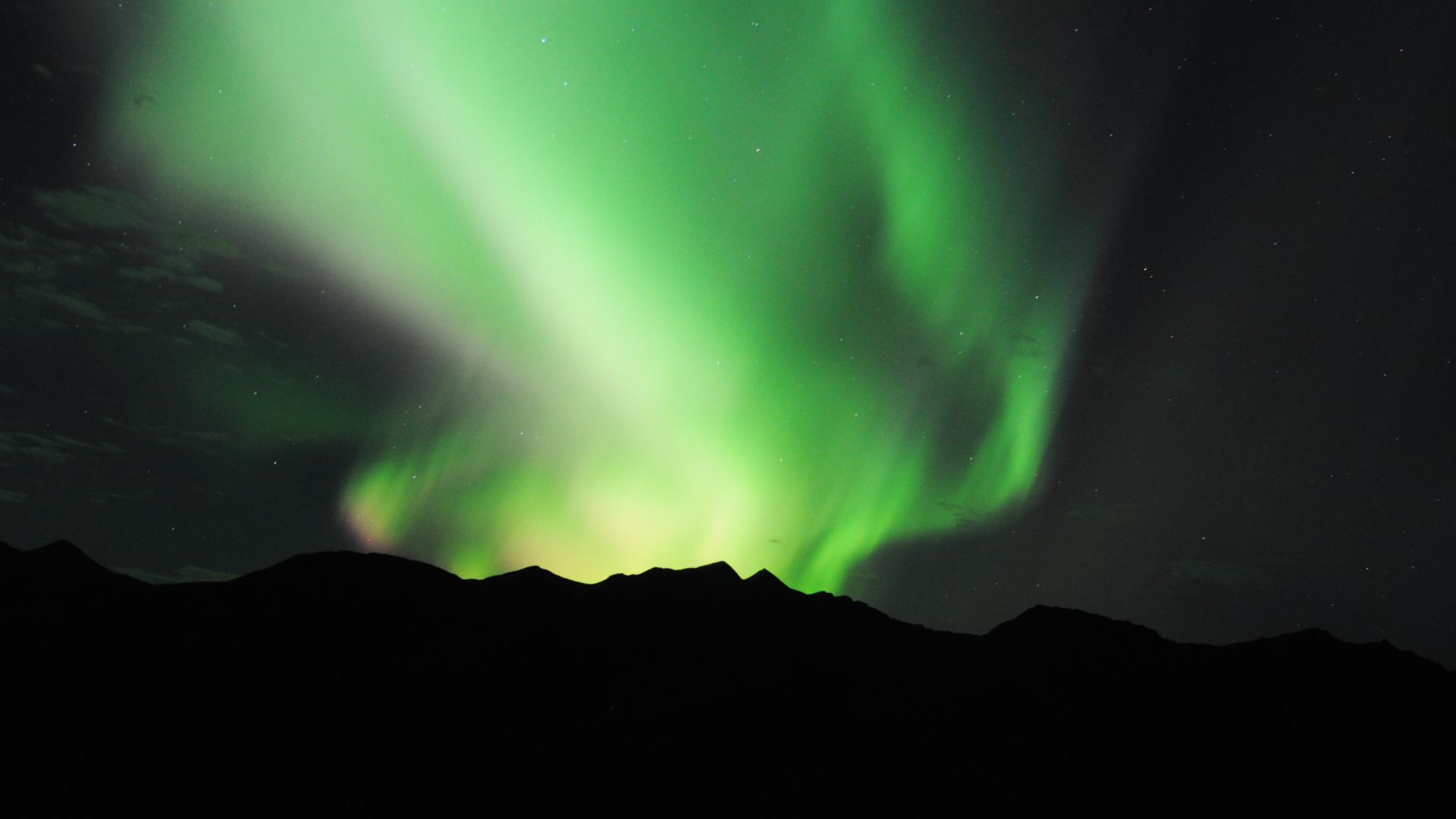 The northern lights ripple above the eastern Alaska Range