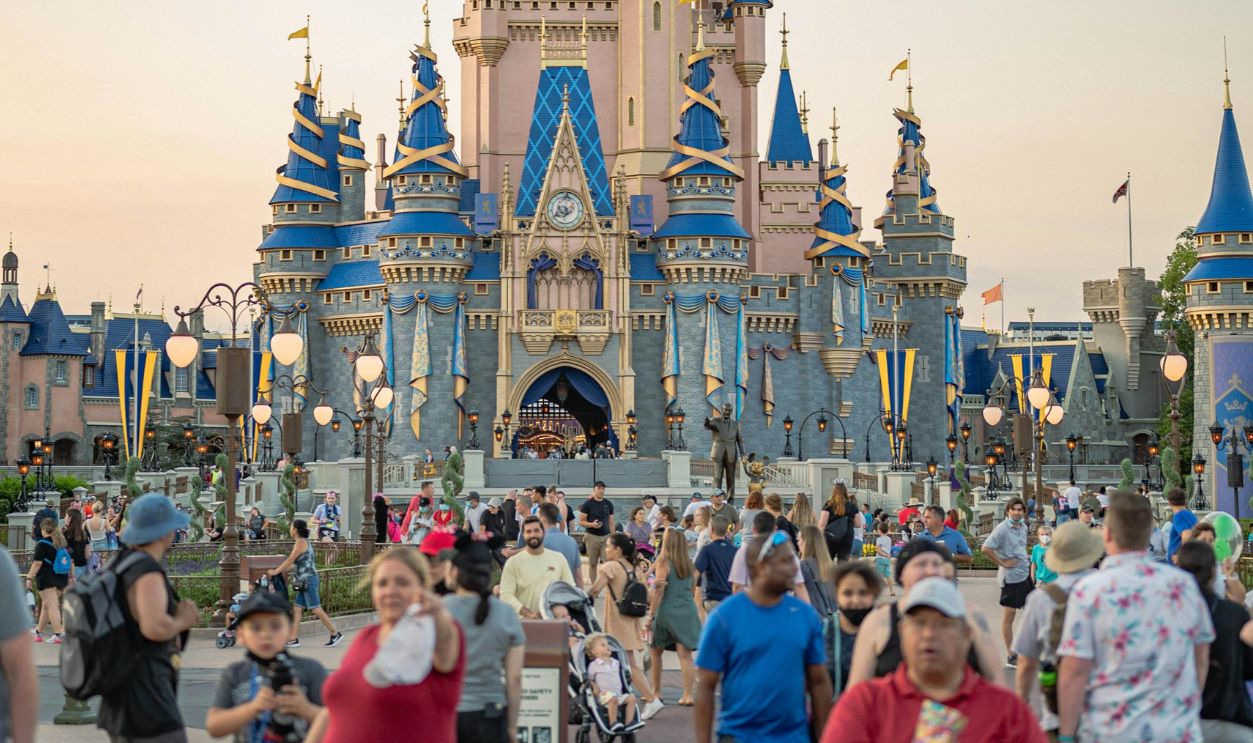 Capture the magic at Cinderella Castle, surrounded by tourists 