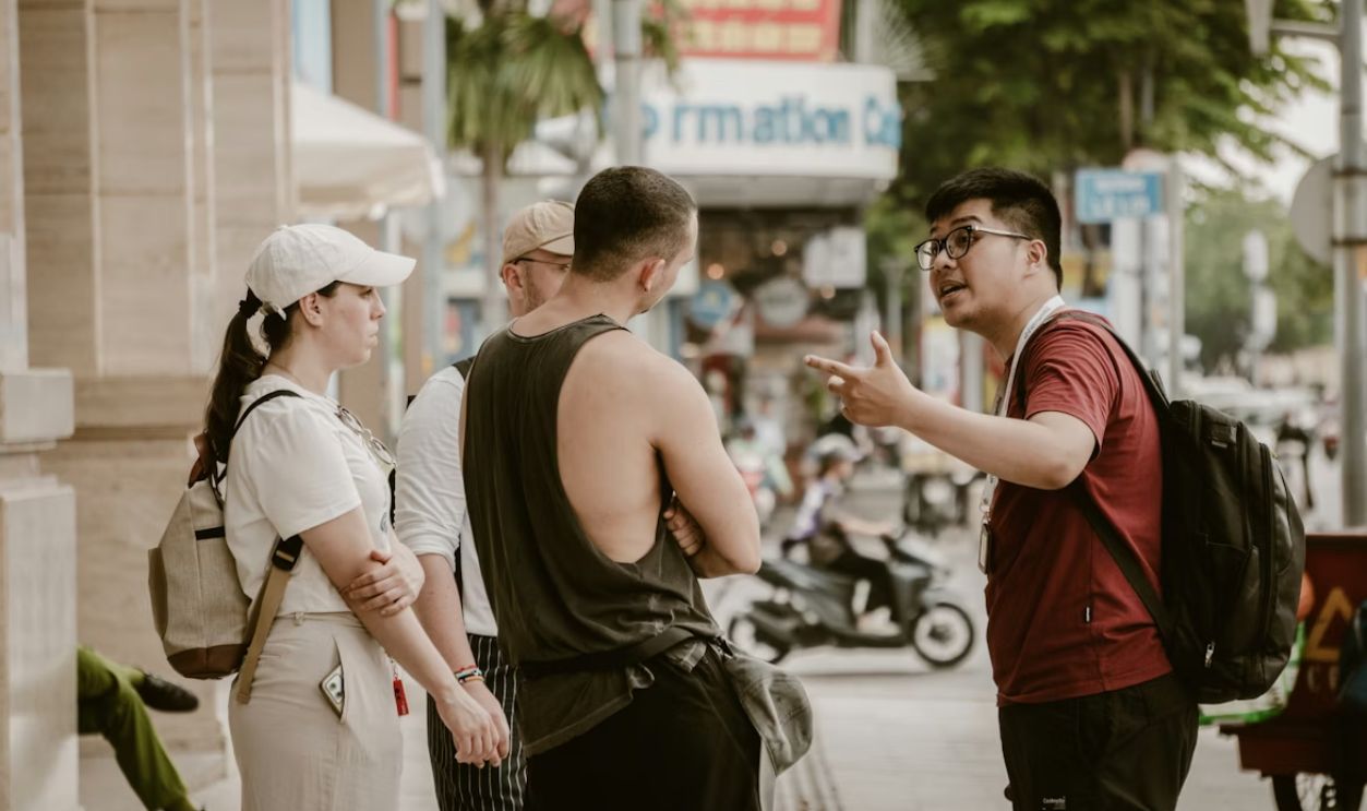 Group of people talking on a city street.