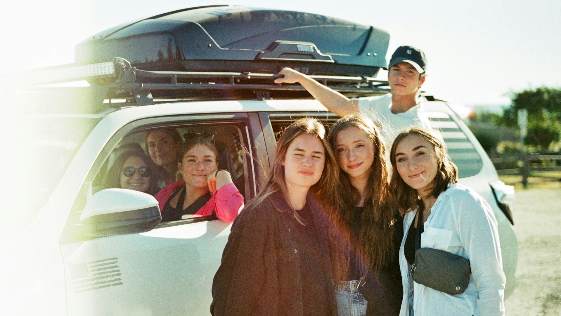 a group of people standing in front of a van