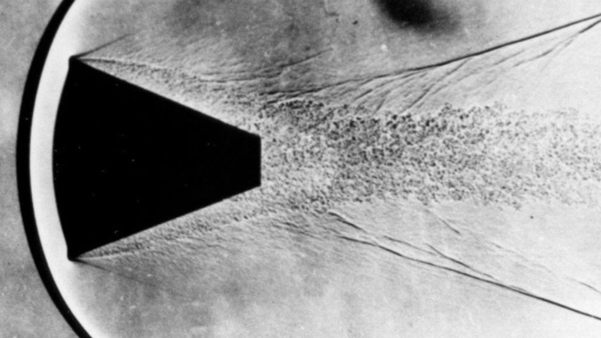 Shadowgraph photo of experiment with shape of Mercury spacecraft from 1960, showing a protective layer in front of the blunt end.
