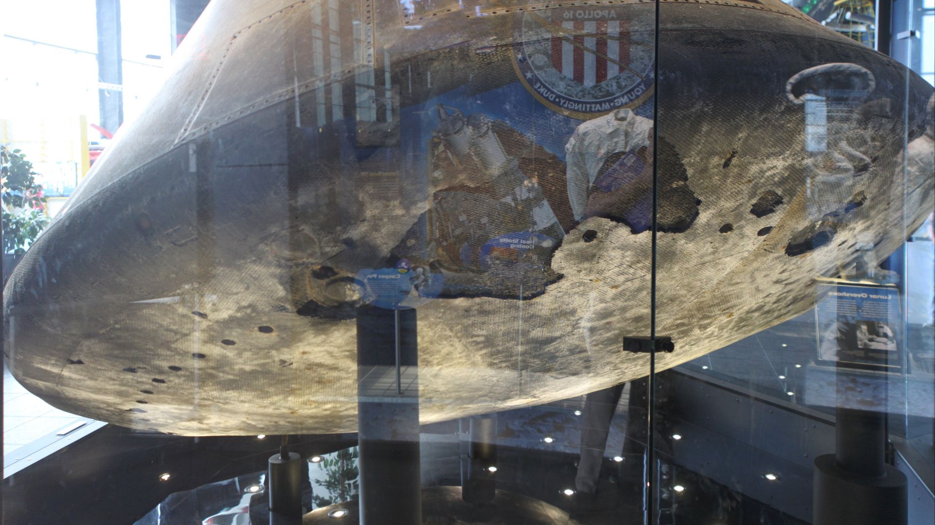 The Apollo 16 heat shield shows scorching and ablation from the heat of reentry.