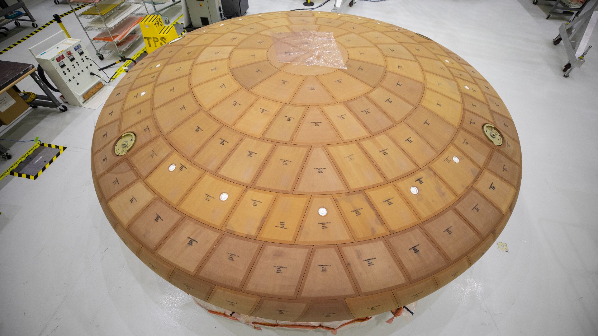 Inside the Neil Armstrong Operations and Checkout Building high bay at NASA's Kennedy Space Center in Florida, the AVOCAT block bonding is complete on the Artemis II heat shield on July 2, 2020. The heat shield is one of the most critical elements of Orio