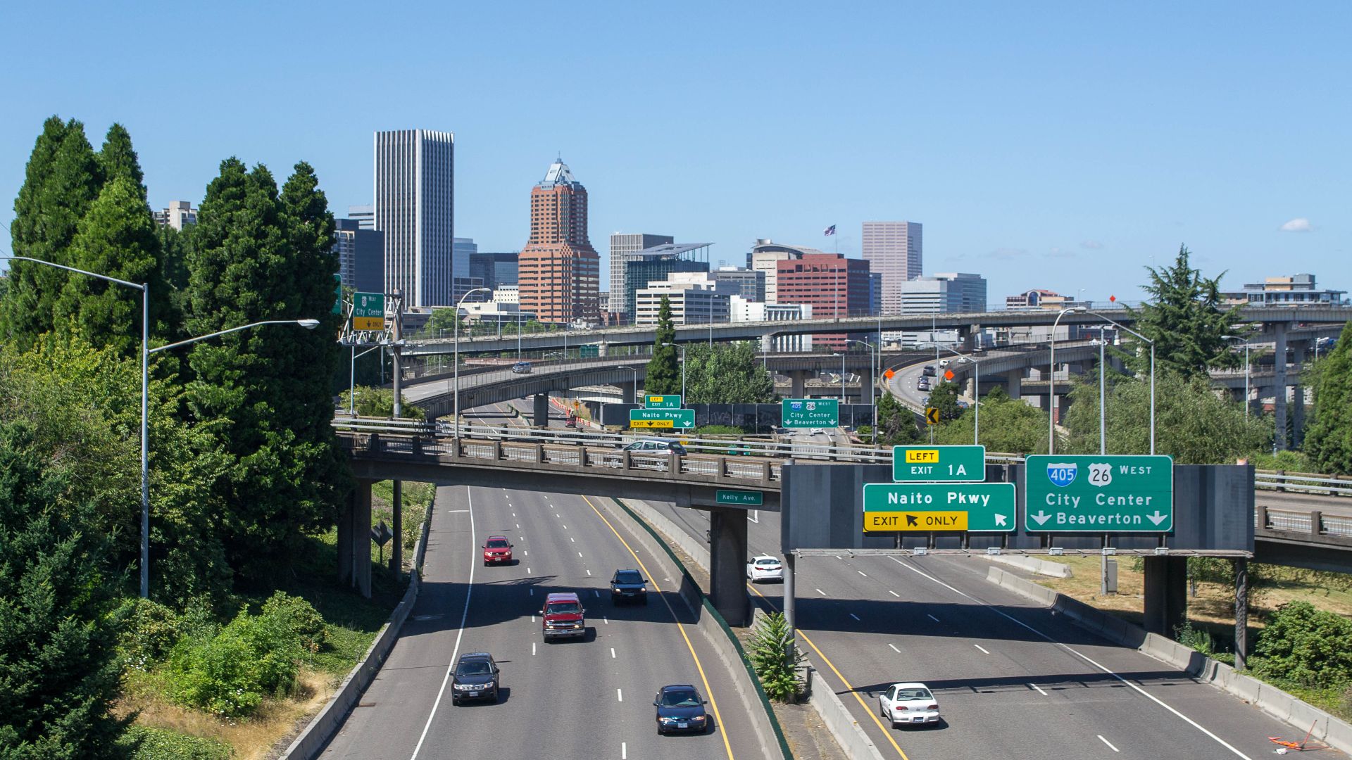 Portland seen from the westernmost section of the Ross Island Bridge, with Interstate 5 in the foreground and the viaducts of the southern I-5/I-405 interchange in the center of the view