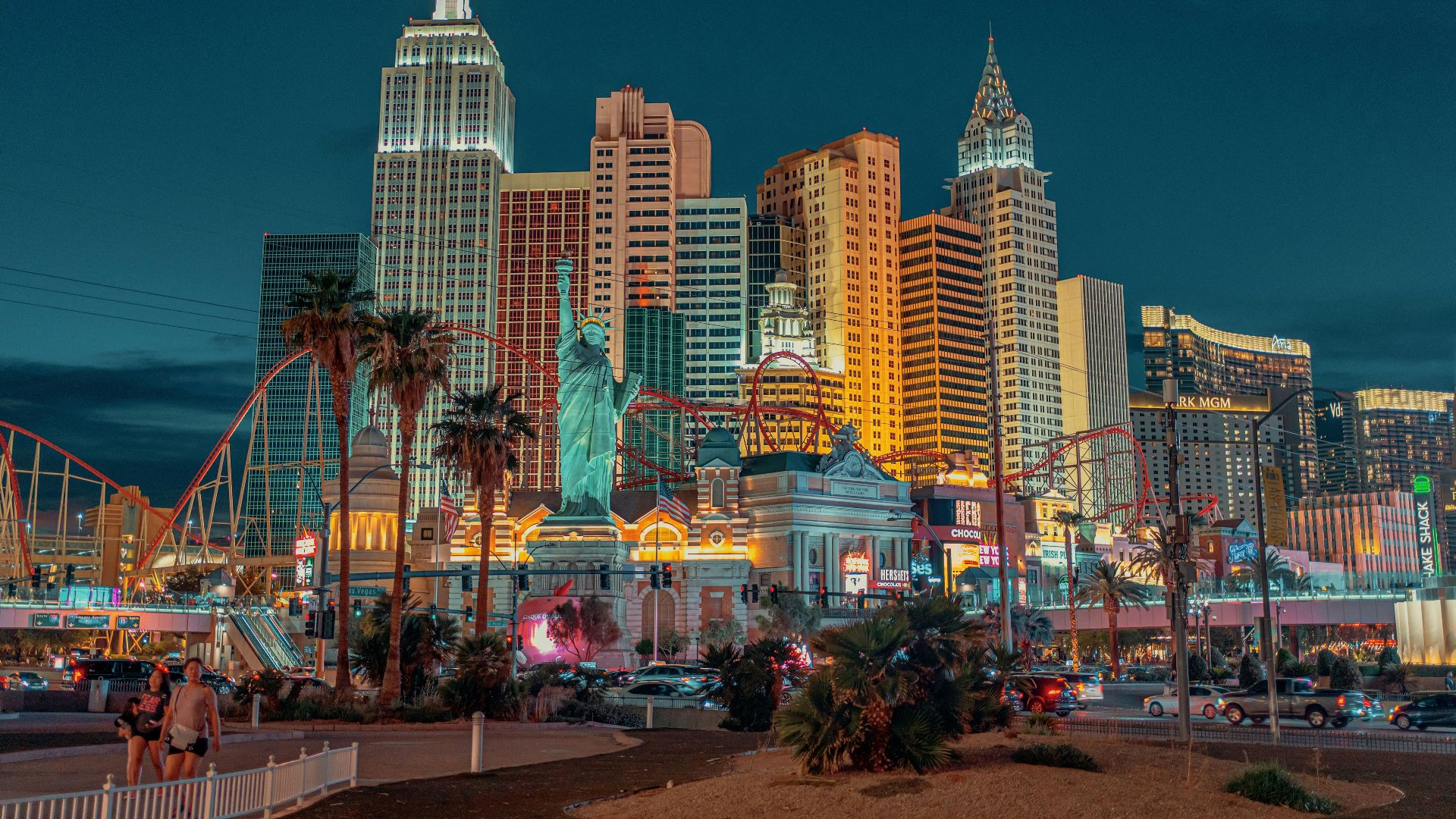 New York-New York Hotel and Casino with a statue and a body of water