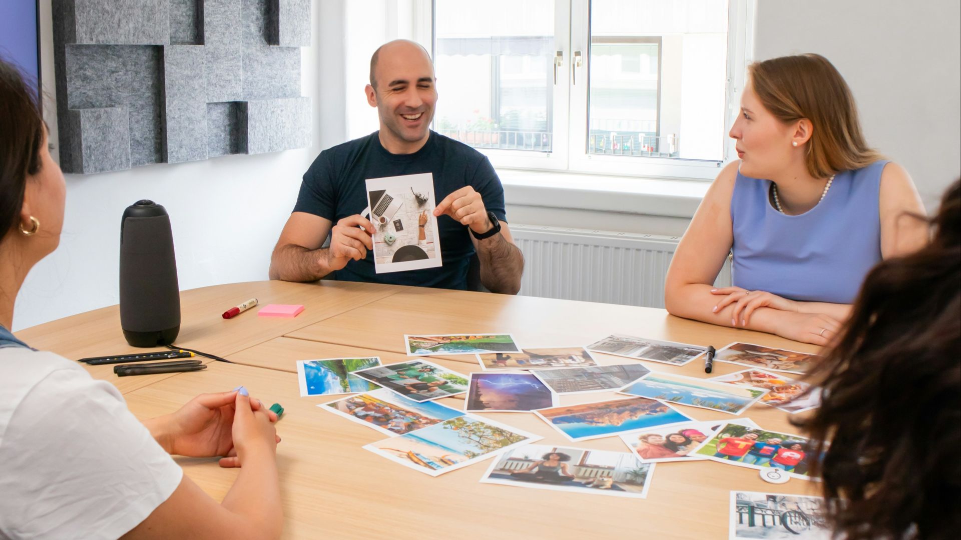 a group of people sitting around a wooden table