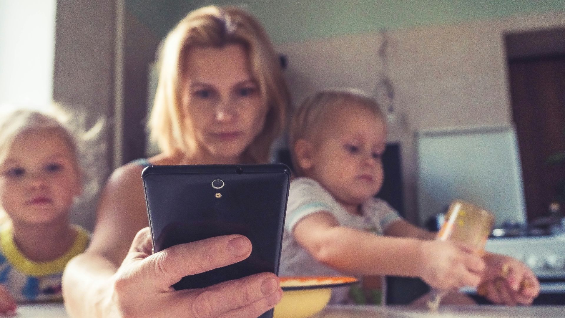 woman in white shirt holding black ipad
