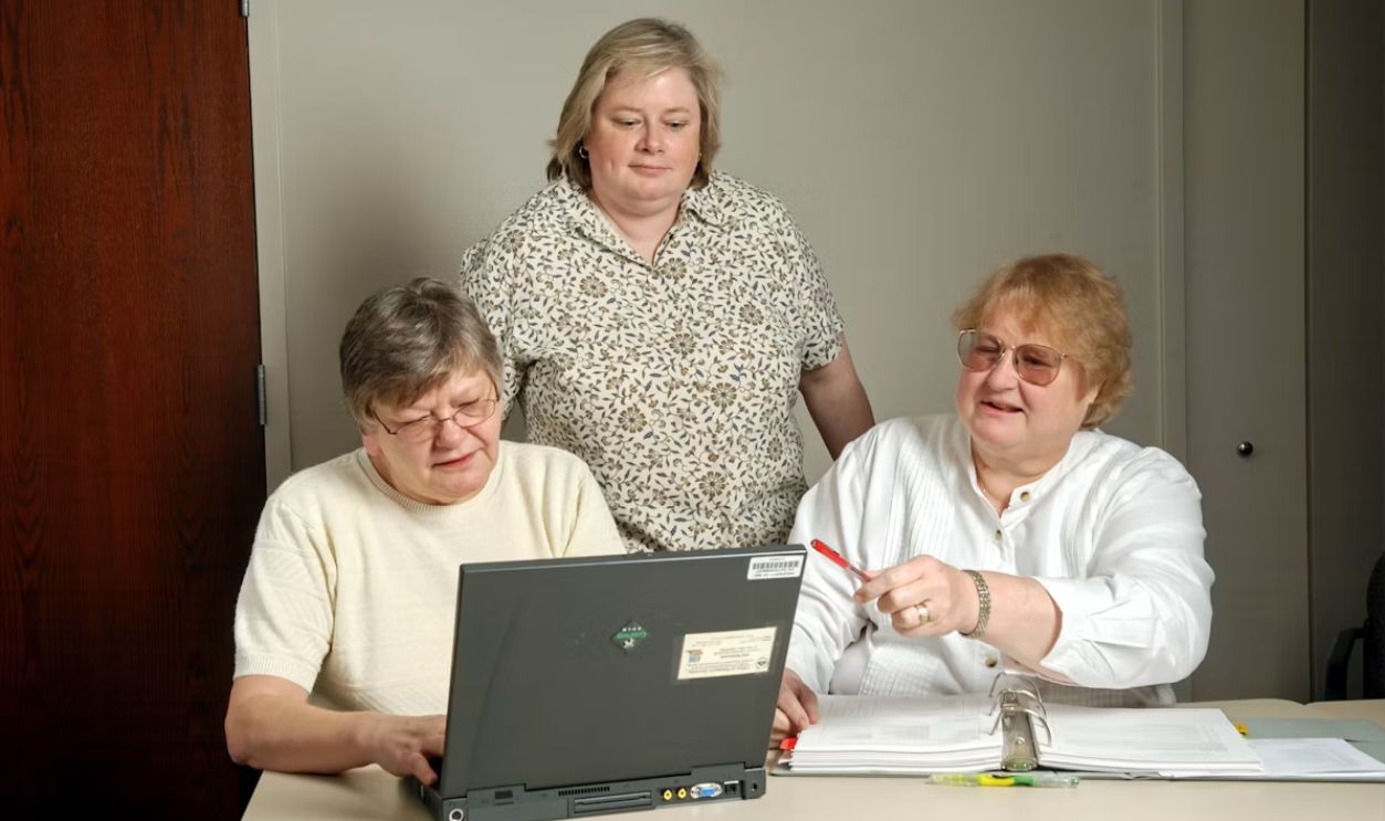 Family members around a laptop