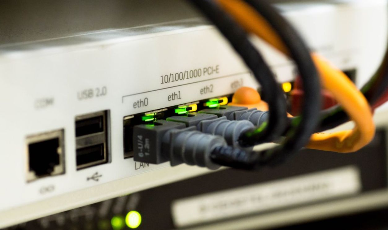 Detailed close-up of ethernet cables and network connections on a router, showcasing modern technology