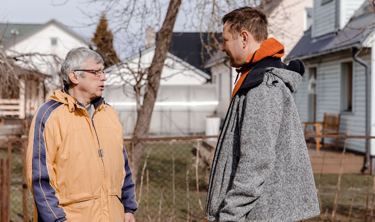 Shutterstock-2159938845, Mature man talking with his elderly father in a garden