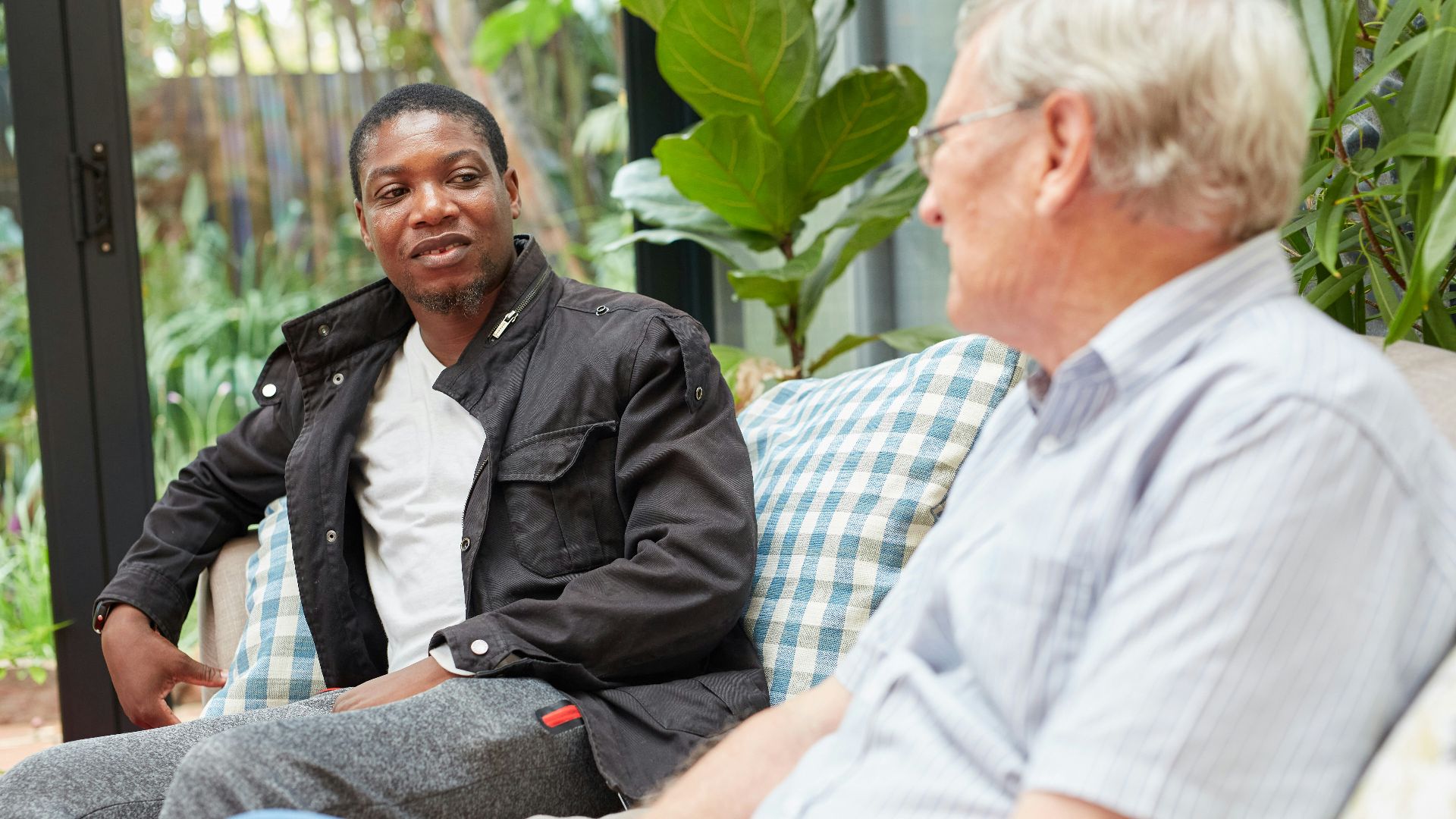 a couple of people sitting on top of a couch