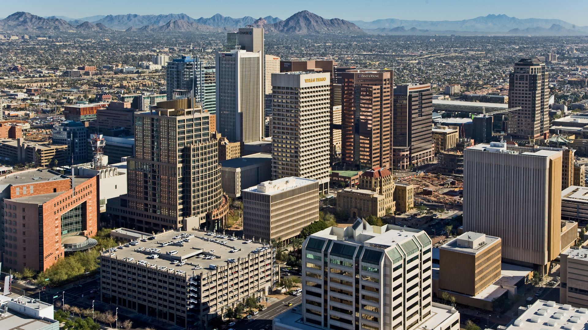 Skyline view of Phoenix — looking northeast from a helicopter, from above the 4th Avenue Jail. 
Foreground is the Central City Village and Central Avenue Corridor of Downtown Phoenix.
In the foreground Municipal and County Courts are visible along with ot