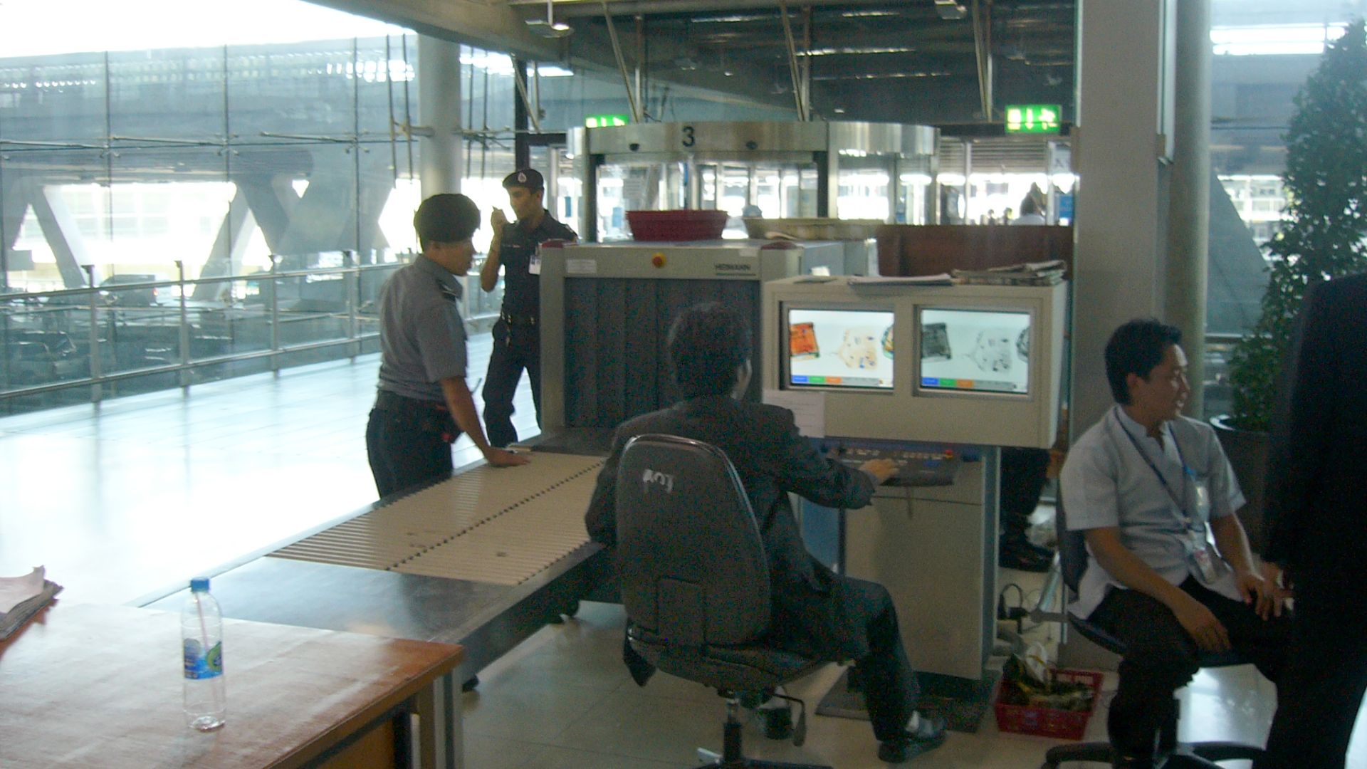 Luggage screening device at Suvarnabhumi International Airport, Bangkok, Thailand. This security post is located for entering the airport which means all people (visitors and passengers) have to pass such a control. Another control will be for boarding lu