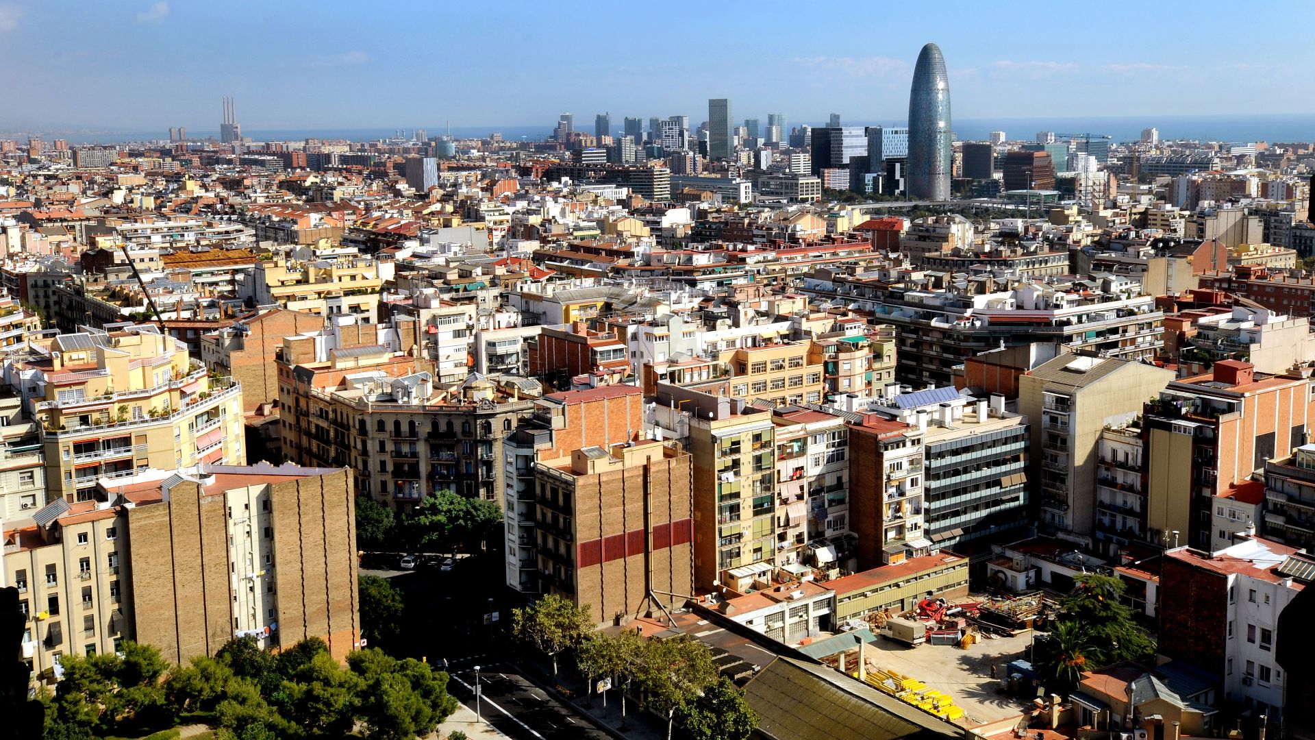 Barcelona, Spain, view over the city towards the coast with Torre Agbar, which is illuminate at night in the colours of the “F. C. Barcelona”