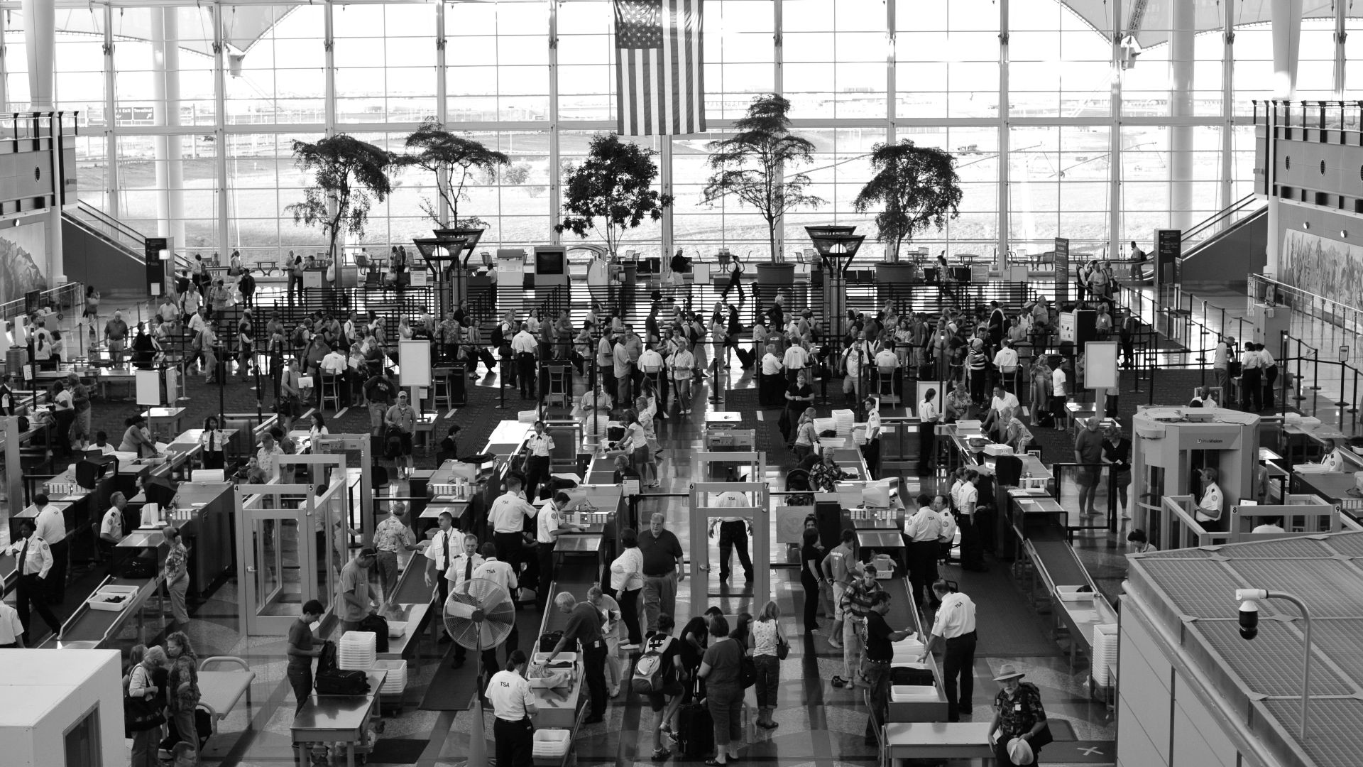 a black and white photo of people in an airport