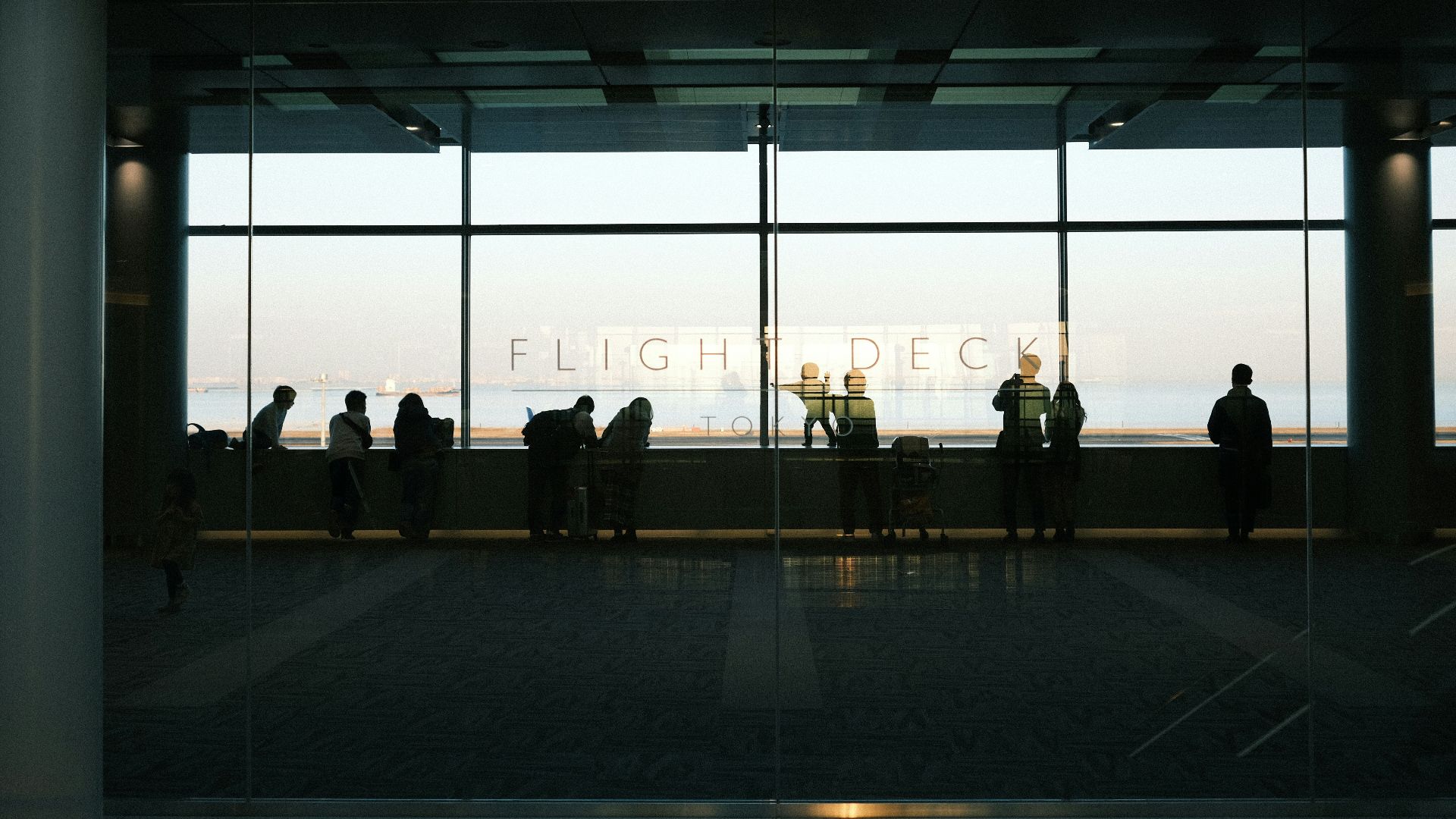 A group of people standing in front of a window