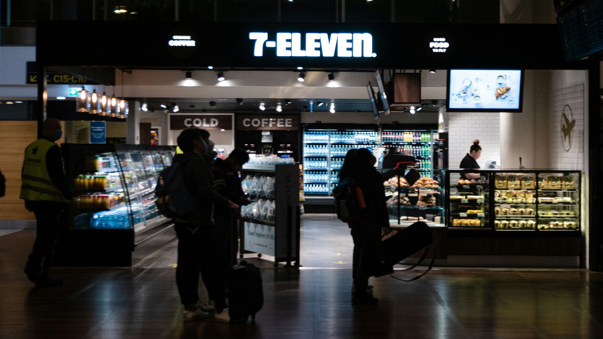 a group of people standing in front of a store