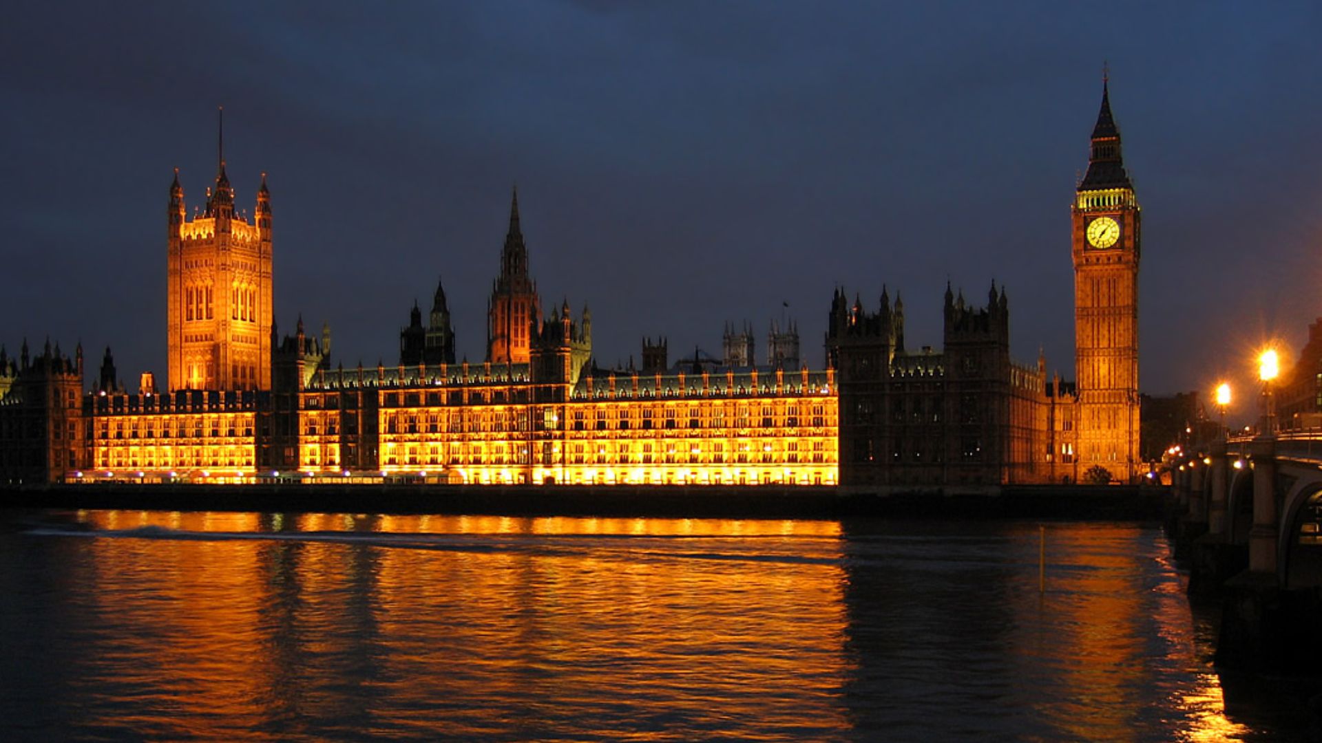 The Palace of Westminster at night seen from the south bank of the River Thames.
Victoria Tower and the House of Lords is on the left. The Clock Tower of Big Ben and the House of Commons is on the right. The spire left of centre is the 300ft ventilation c