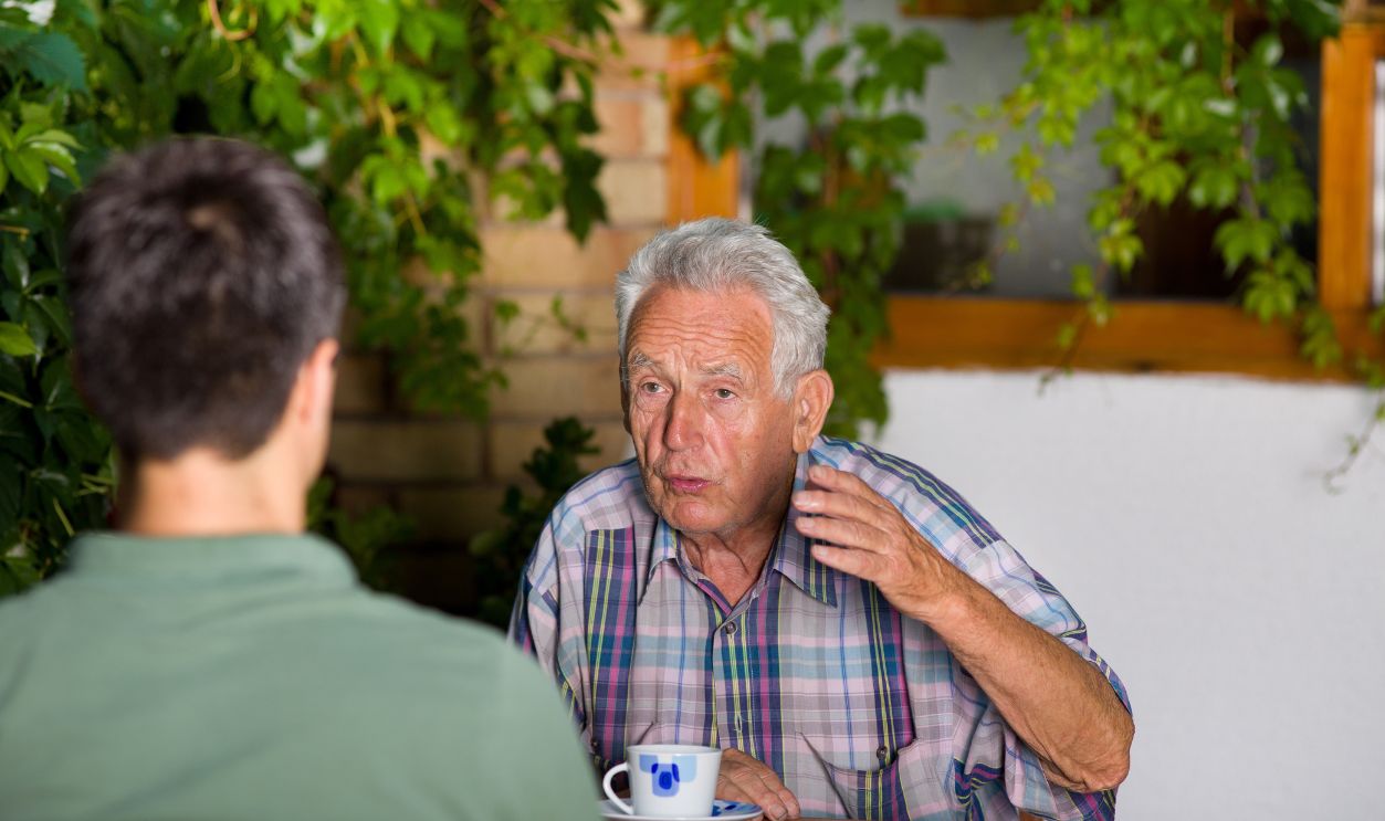 Shutterstock-213649564, Serious old man talking with grandson and explaining by hand
