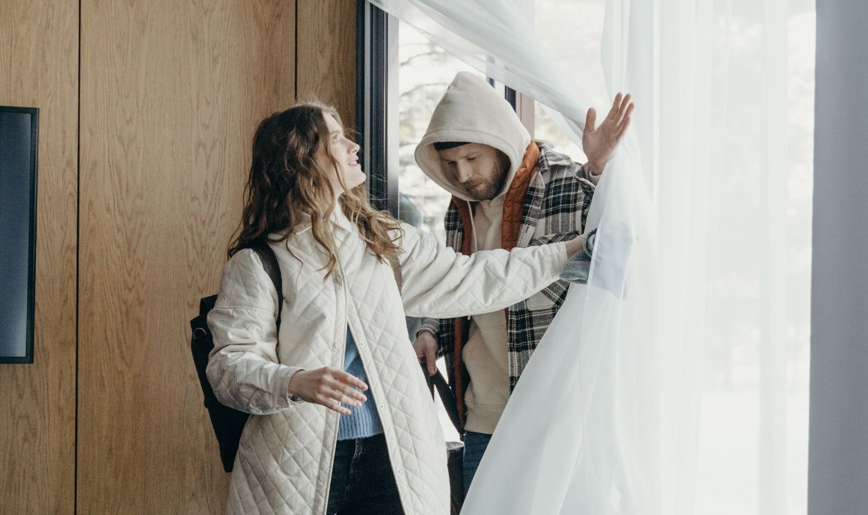 A couple enjoys a cozy moment in a winter cabin, embracing relaxation indoors