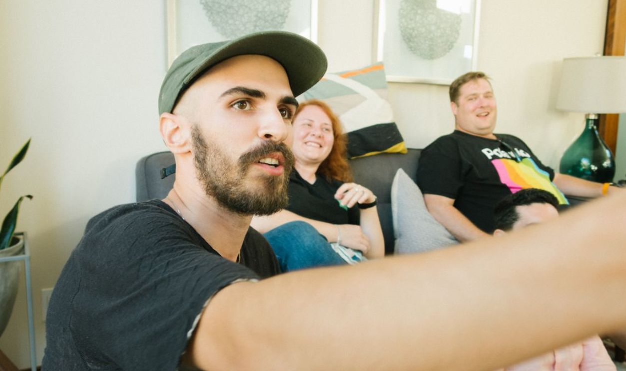 Casual gathering of friends laughing and enjoying indoors on a cozy sofa